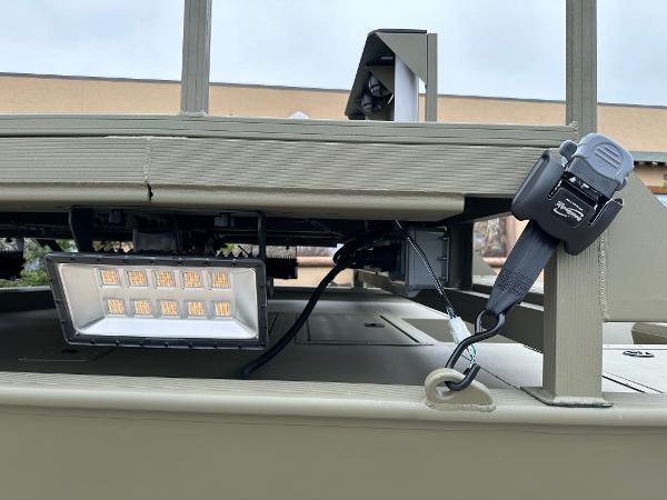 2025 Tracker Grizzly 2072 CC Sportsman boat with mounted LED light and secure strap.