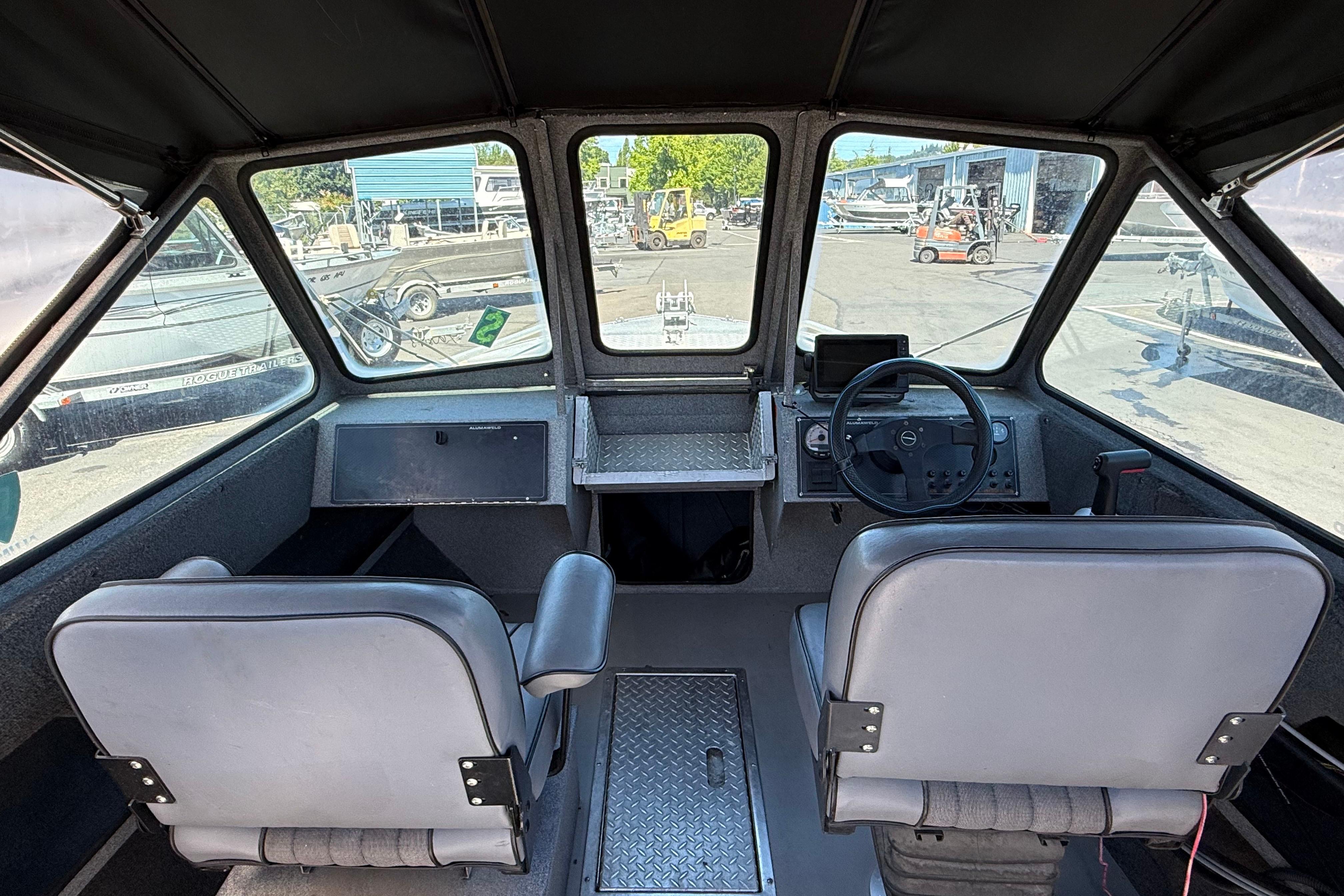 2004 Alumaweld Intruder Outboard 20 boat interior with dual seats and steering console.