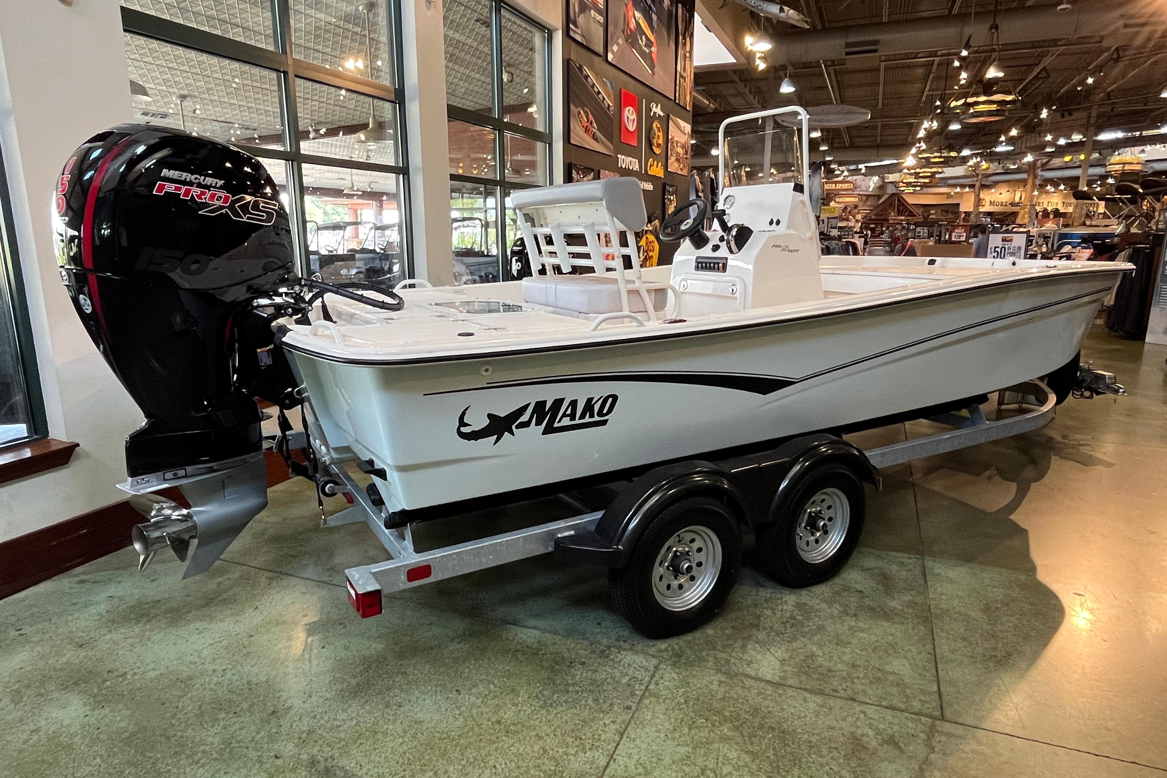 2024 Mako Pro Skiff 19 CC boat on display with Mercury Pro XS engine.