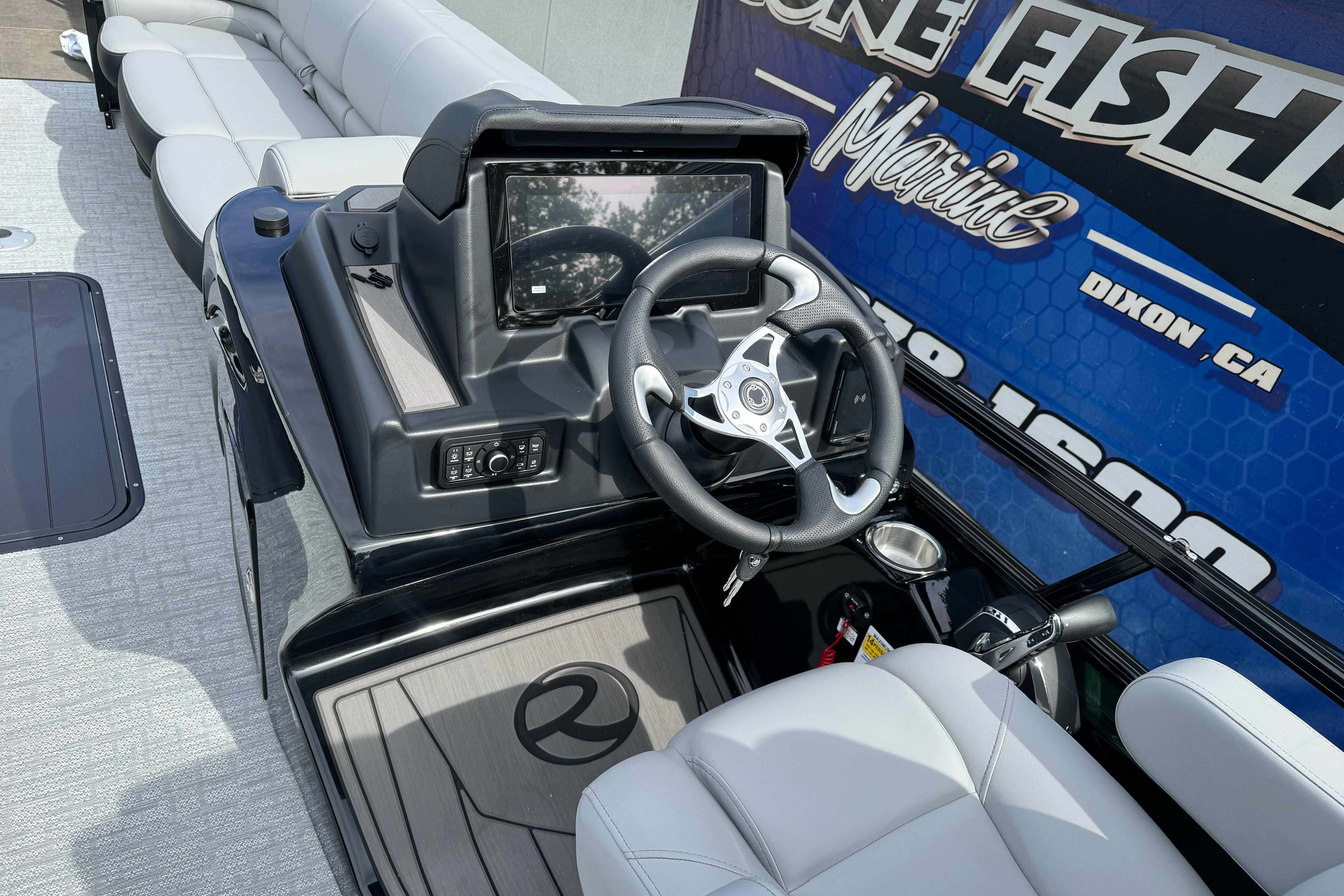 Modern 2026 Regency 250 DL boat dashboard with steering wheel and touchscreen display.