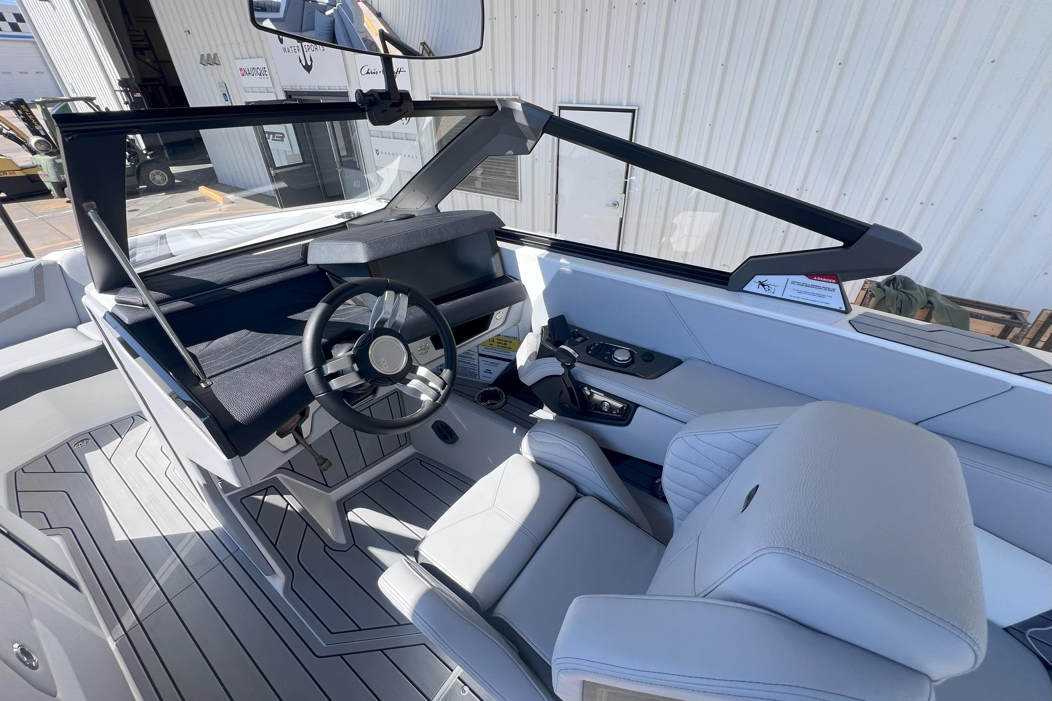 2025 Nautique Super Air Nautique G21 boat interior with modern steering and seating.