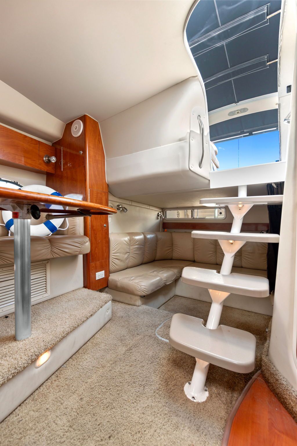 Interior of the 2007 Larson Cabrio 330 with stairs and seating area.