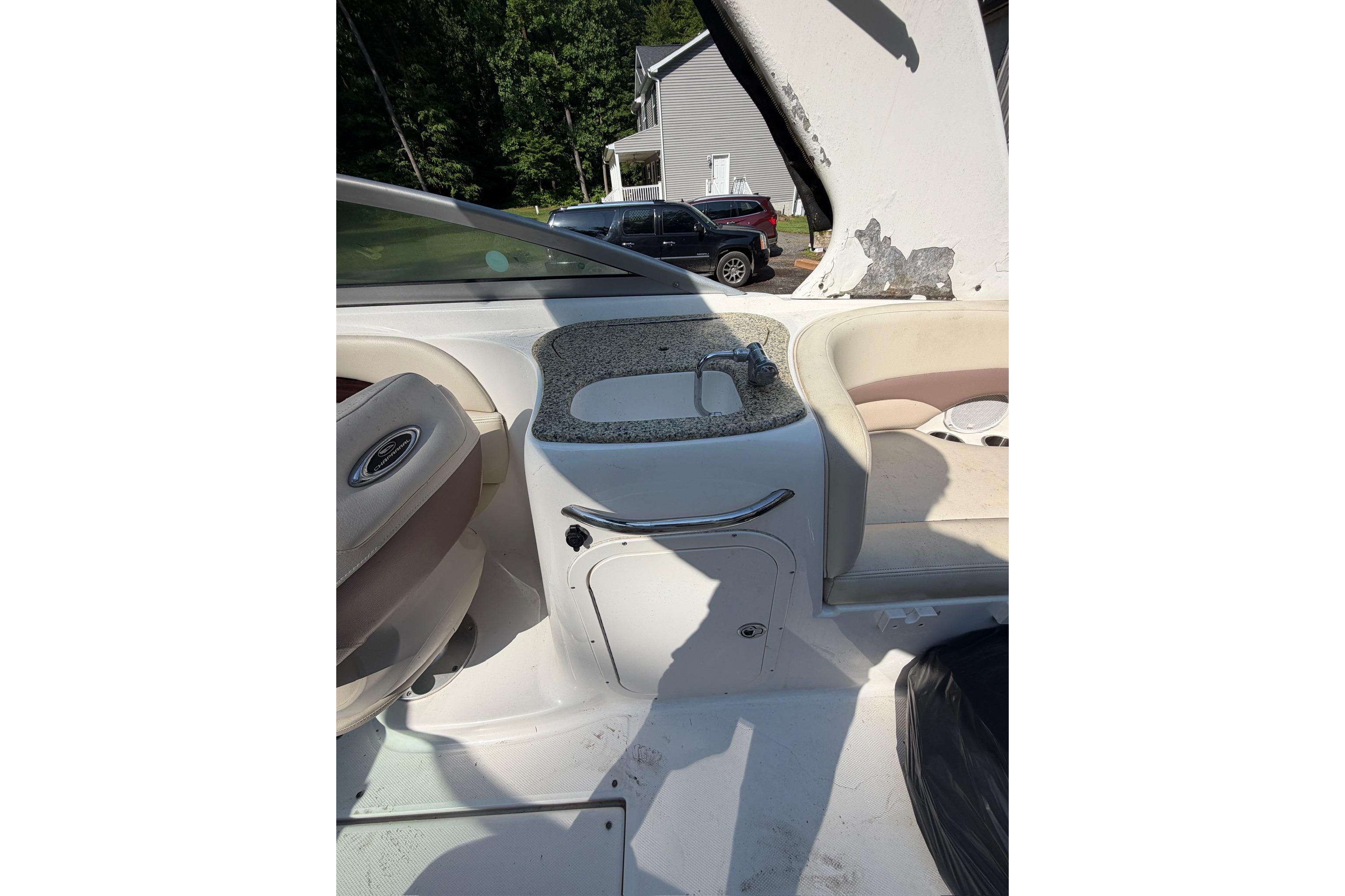 2005 Chaparral 256 SSi boat interior with sink and seating area.