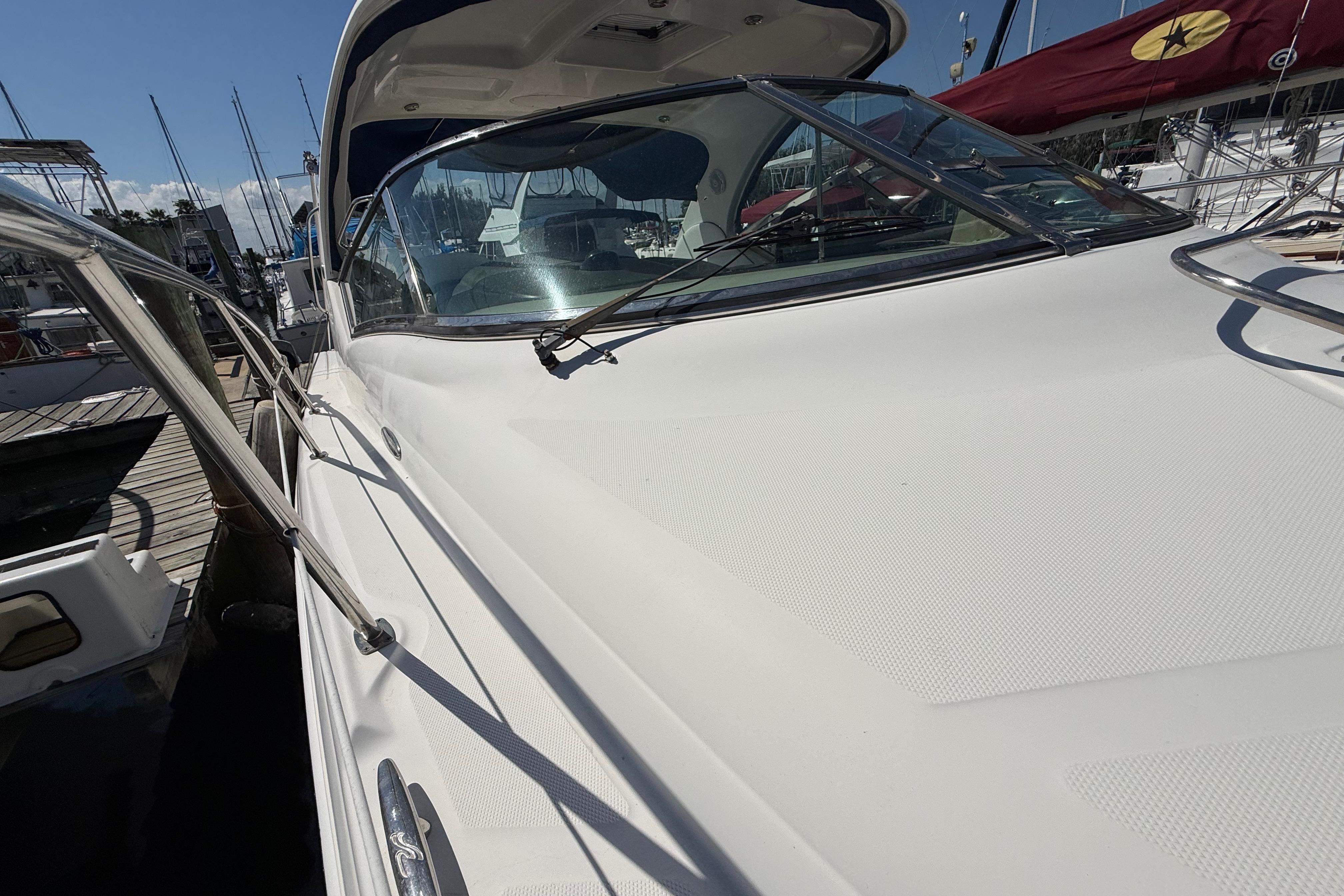 2008 Sea Ray 38 Sundancer yacht docked at marina, showcasing sleek design and windshield.