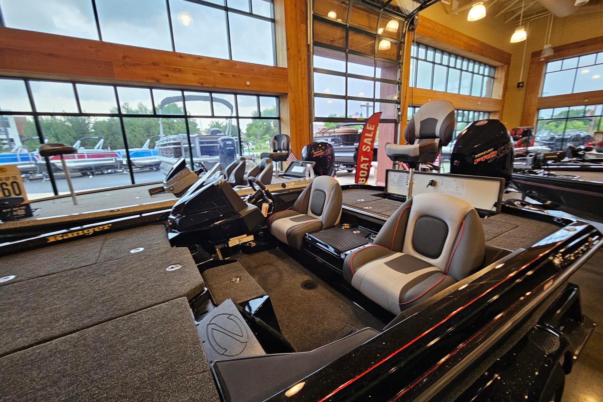 2026 Ranger Z518 Cup-Equipped boat interior in showroom with modern seating and controls.