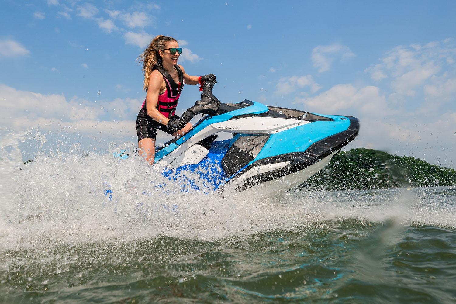 Manufacturer Provided Image: Woman riding 2026 Yamaha WaveRunner JetBlaster DLX 3-Up on water, creating splashes.