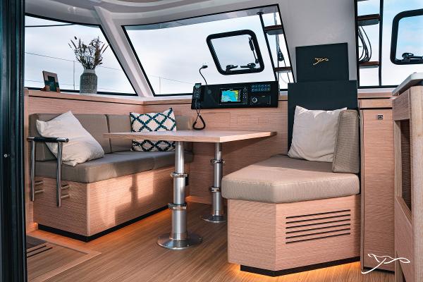 Luxurious interior of 2025 Nautitech 40 Open catamaran with modern seating and navigation equipment.