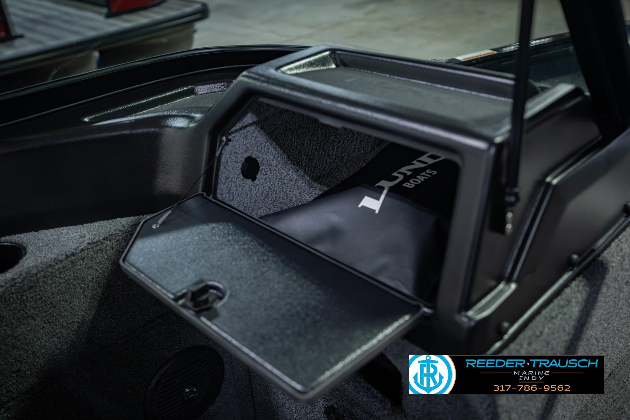2026 Lund 1775 Impact XS boat storage compartment with open lid, showcasing interior space.