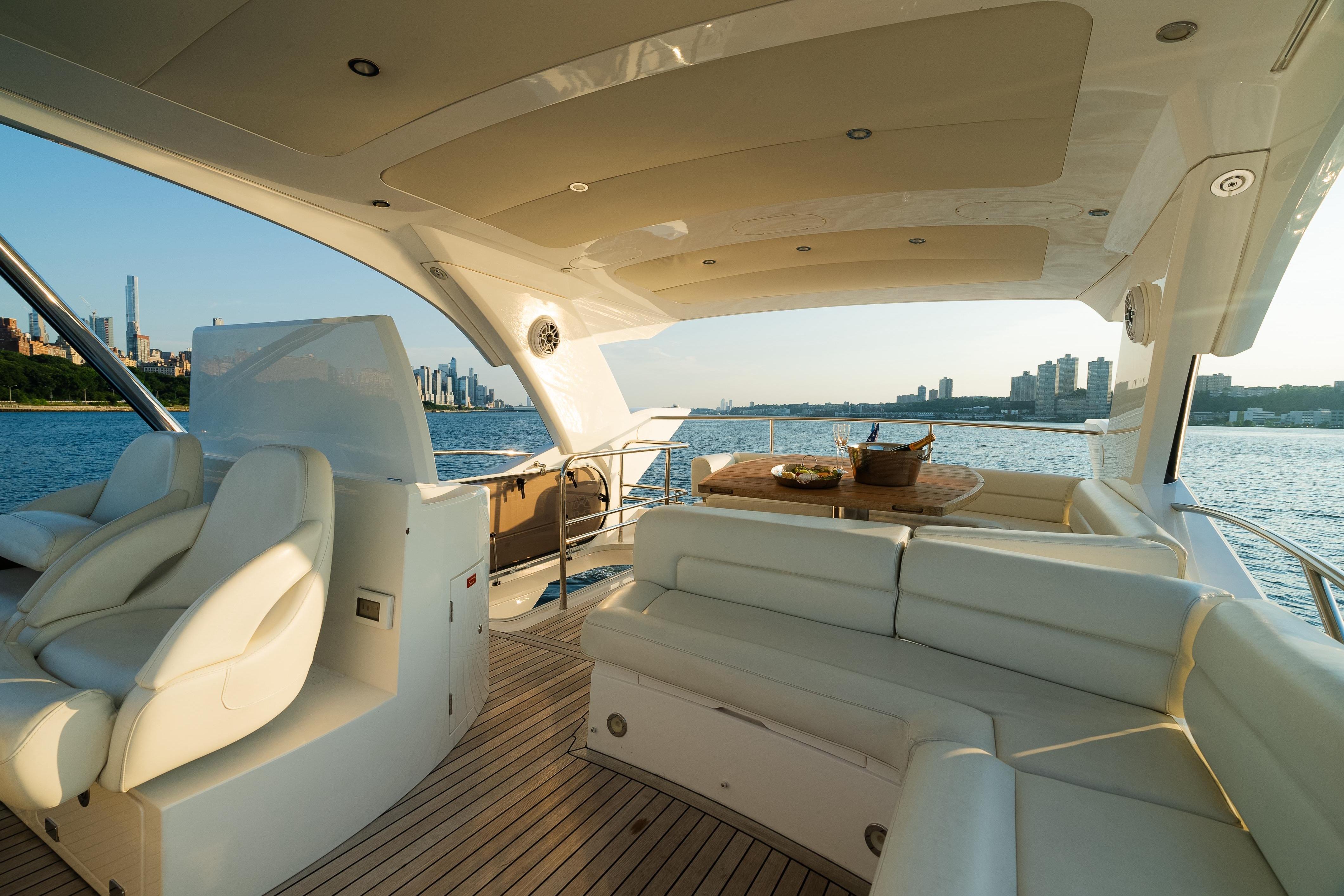 Luxurious 2016 Sunseeker Manhattan 65 yacht interior with city skyline view.
