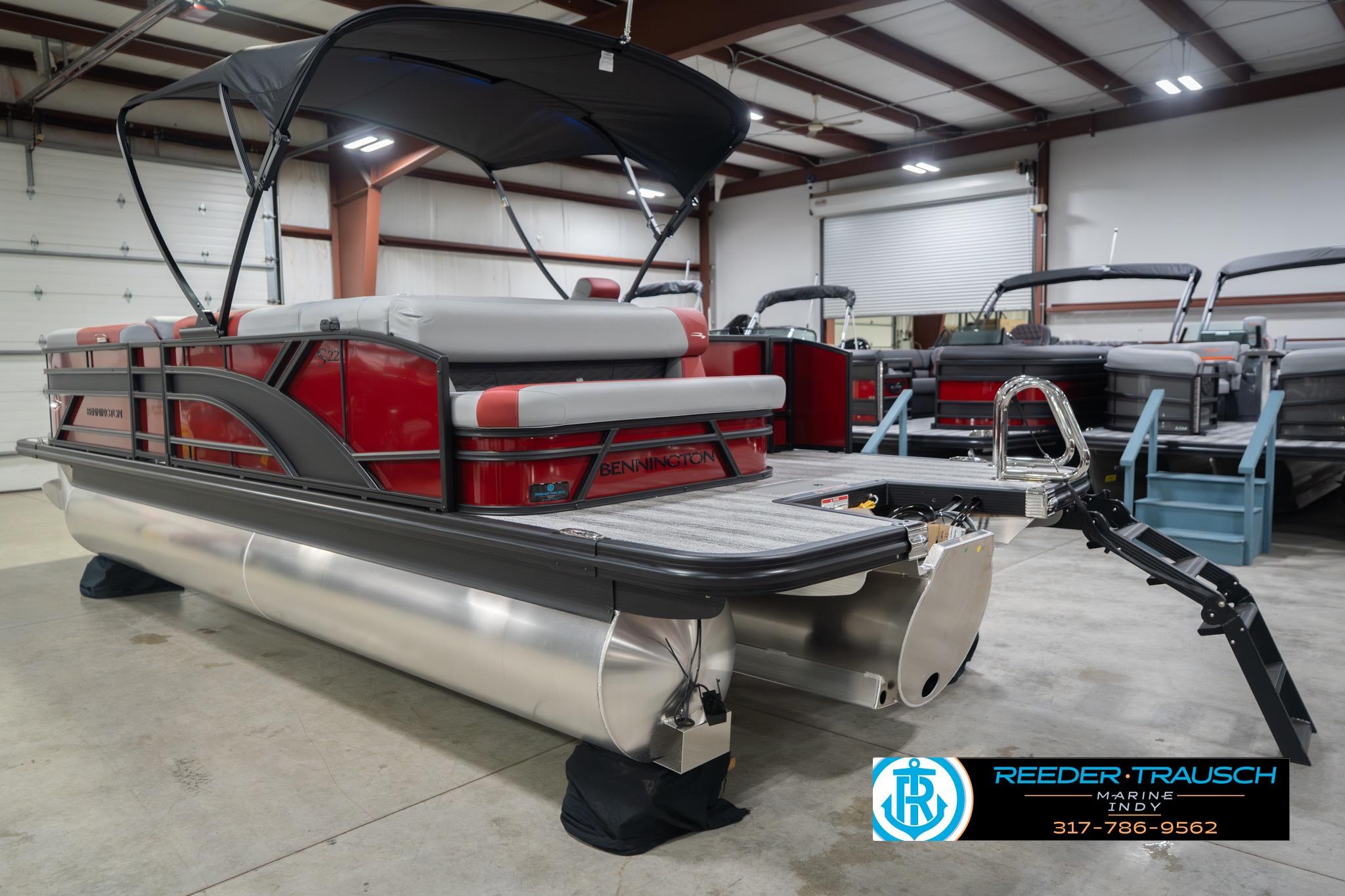 2026 Bennington 22 SLJ pontoon boat in showroom, featuring sleek design and modern amenities.