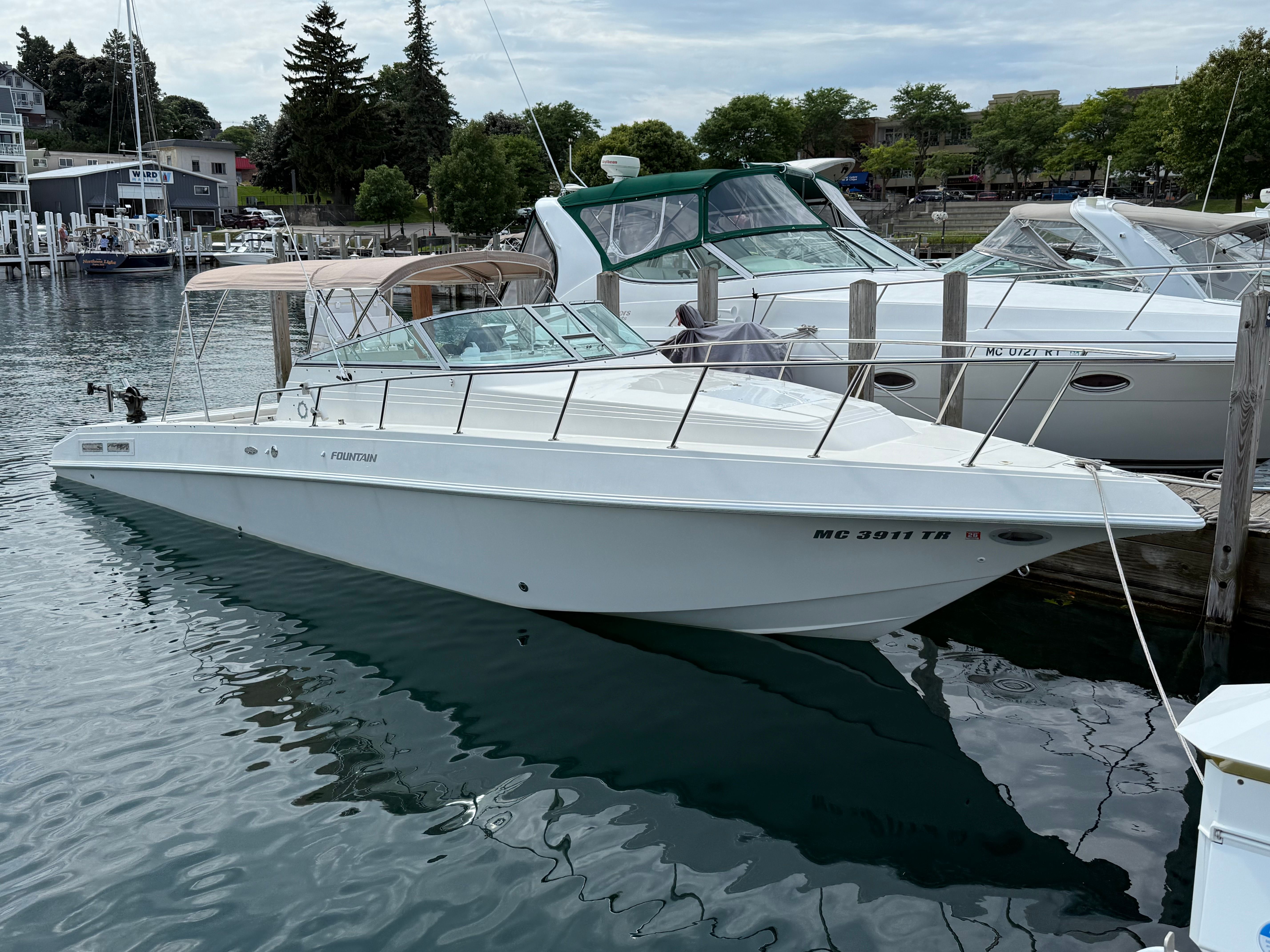 1999 Fountain 32 Sport Fish Cruiser docked at harbor.