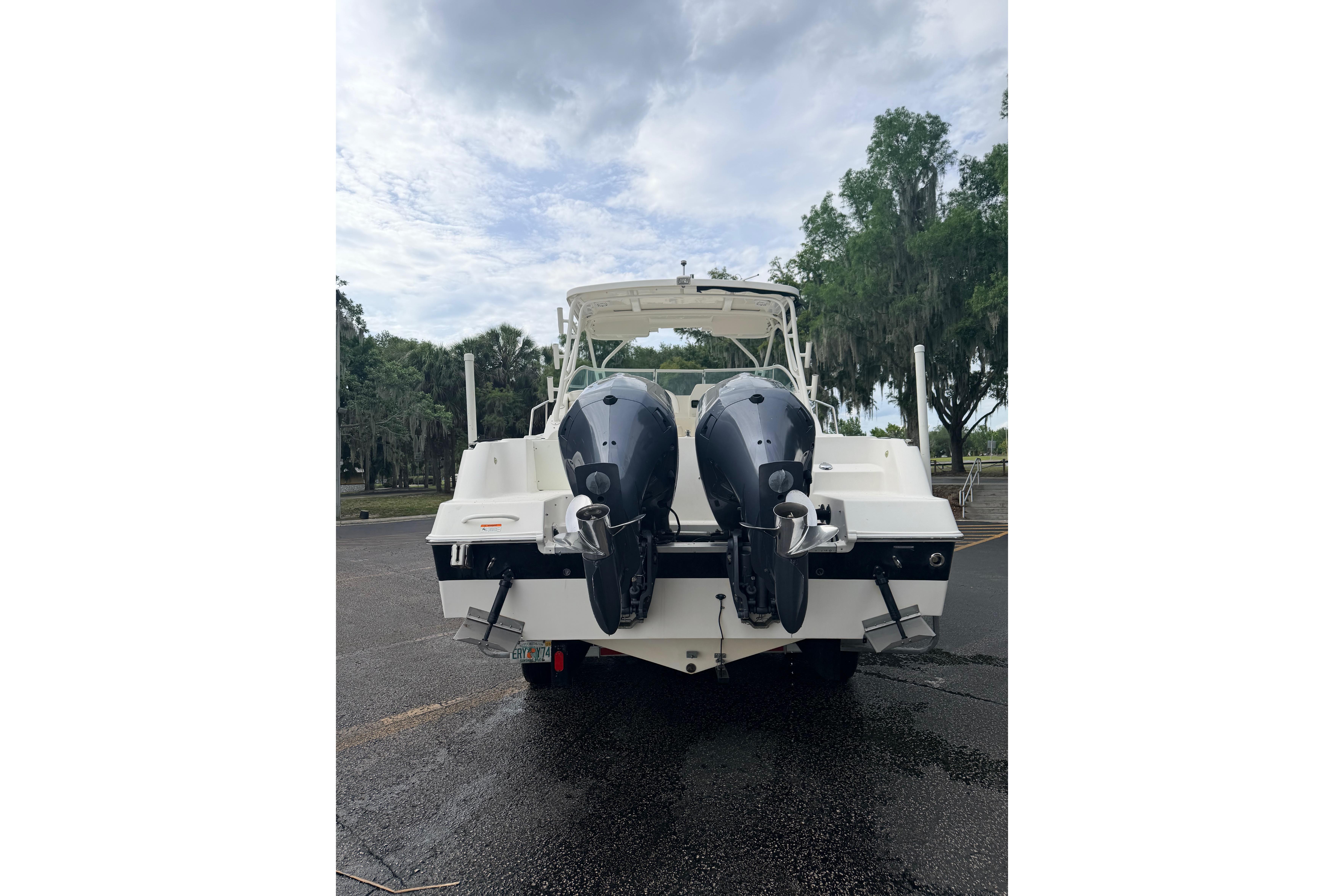 2015 Wellcraft 290 Coastal boat with dual outboard motors, parked outdoors.