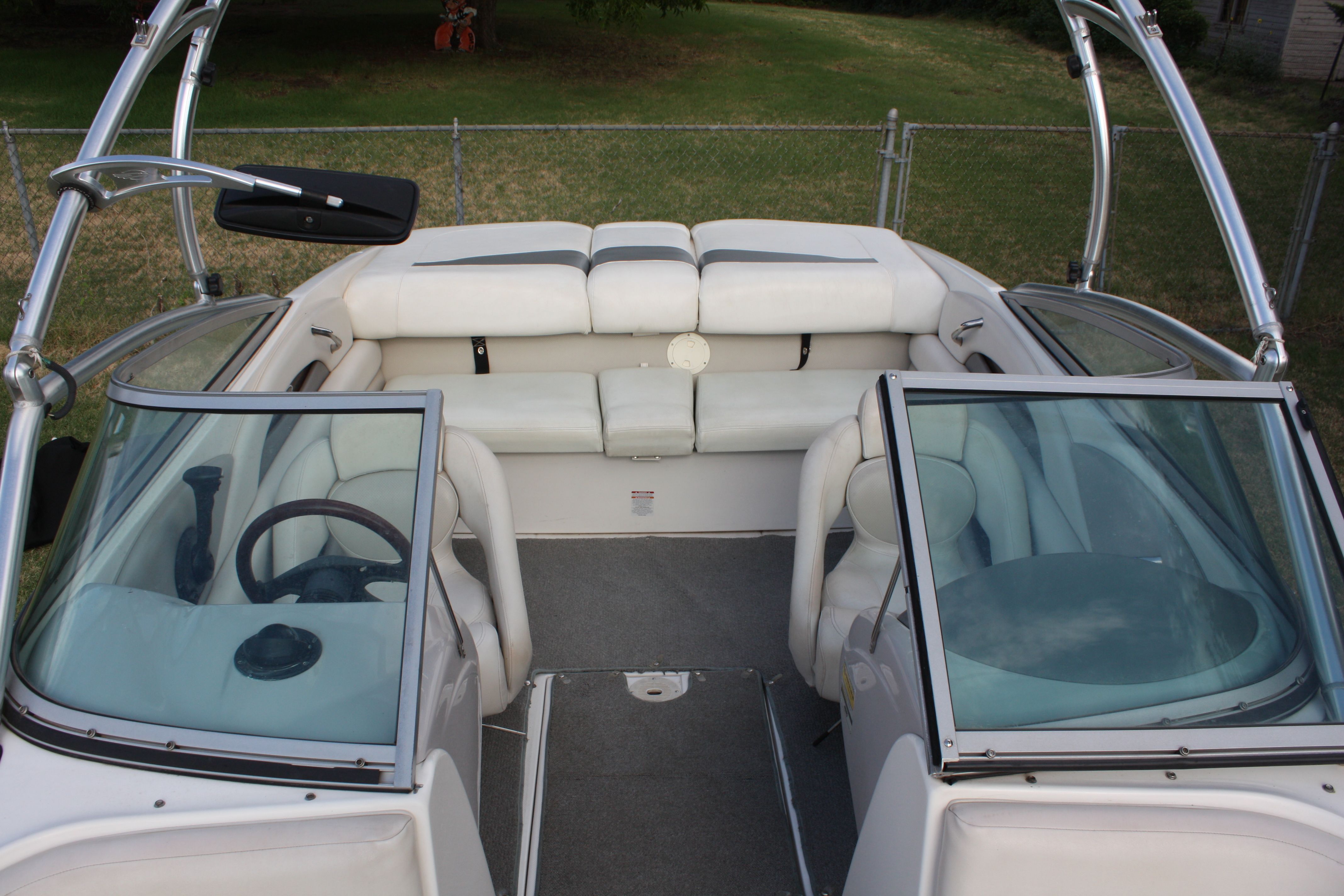 Interior view of a Chaparral 210 SSi boat with white seating and windshields.