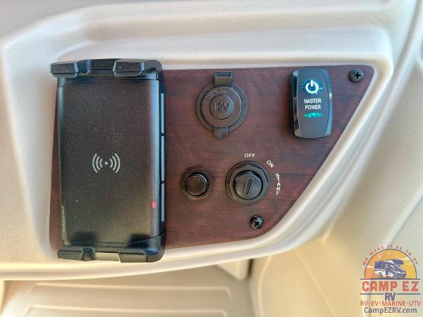 Control panel of 2025 South Bay 224FCR LE with power switches and phone holder.