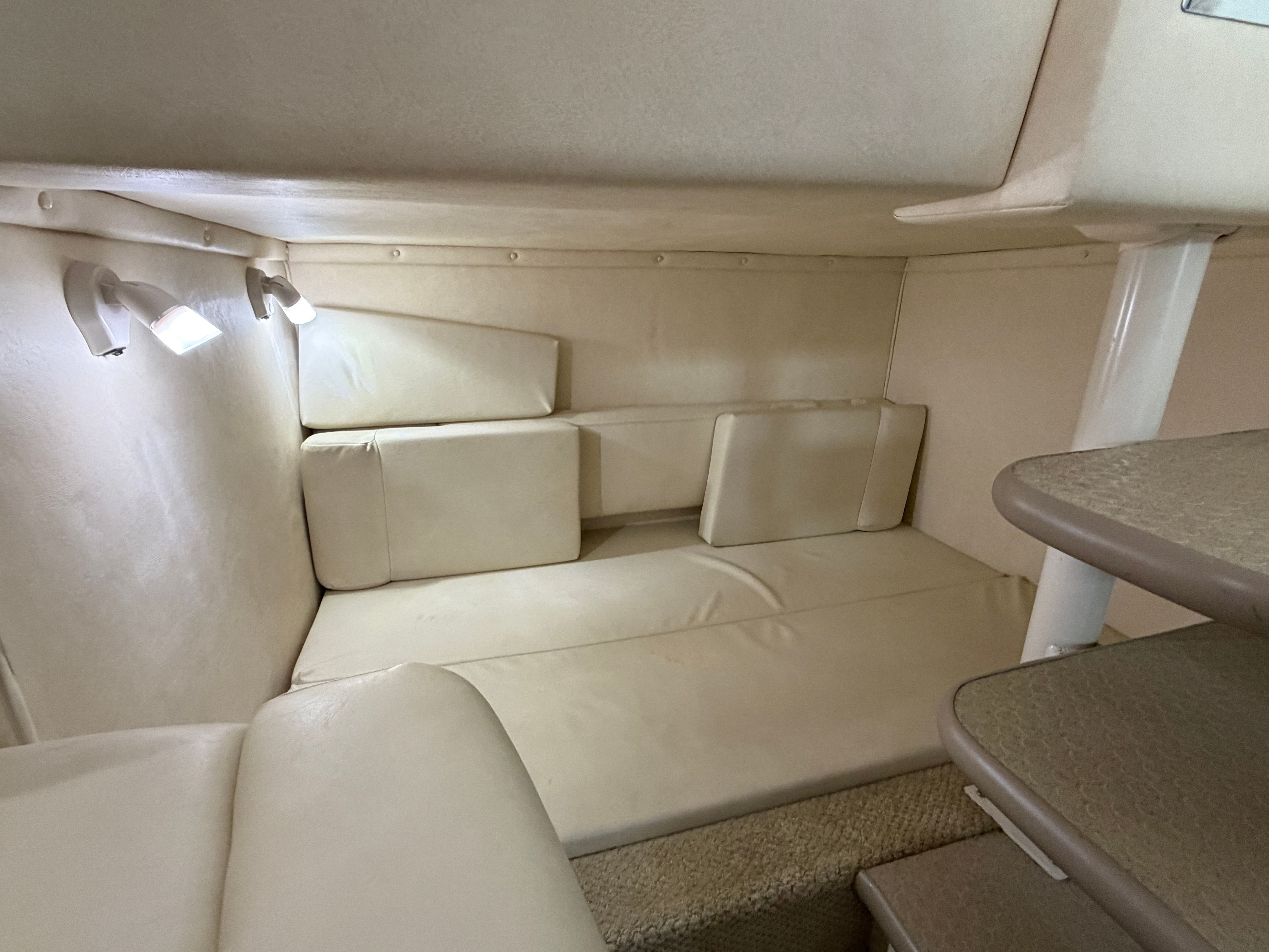 Interior of a 2005 Sea Ray 290 Amberjack with beige upholstery.