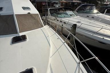 2007 Island Pilot 395 yacht docked alongside other boats in a marina.