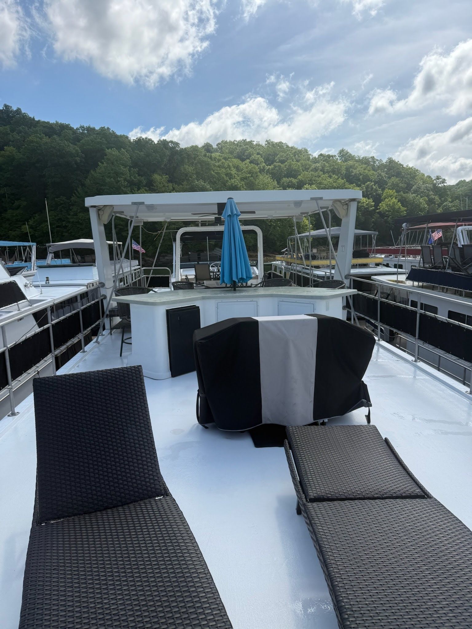 2003 Lakeview 16x70 houseboat with deck loungers and umbrella.