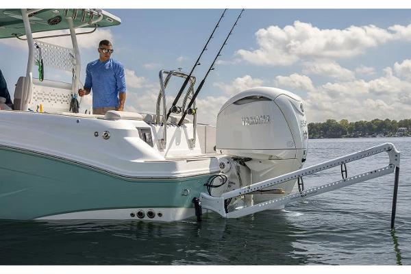 Manufacturer Provided Image: 2026 Hurricane Center Console 24 OB boat on water, featuring sleek design and powerful outboard engine.