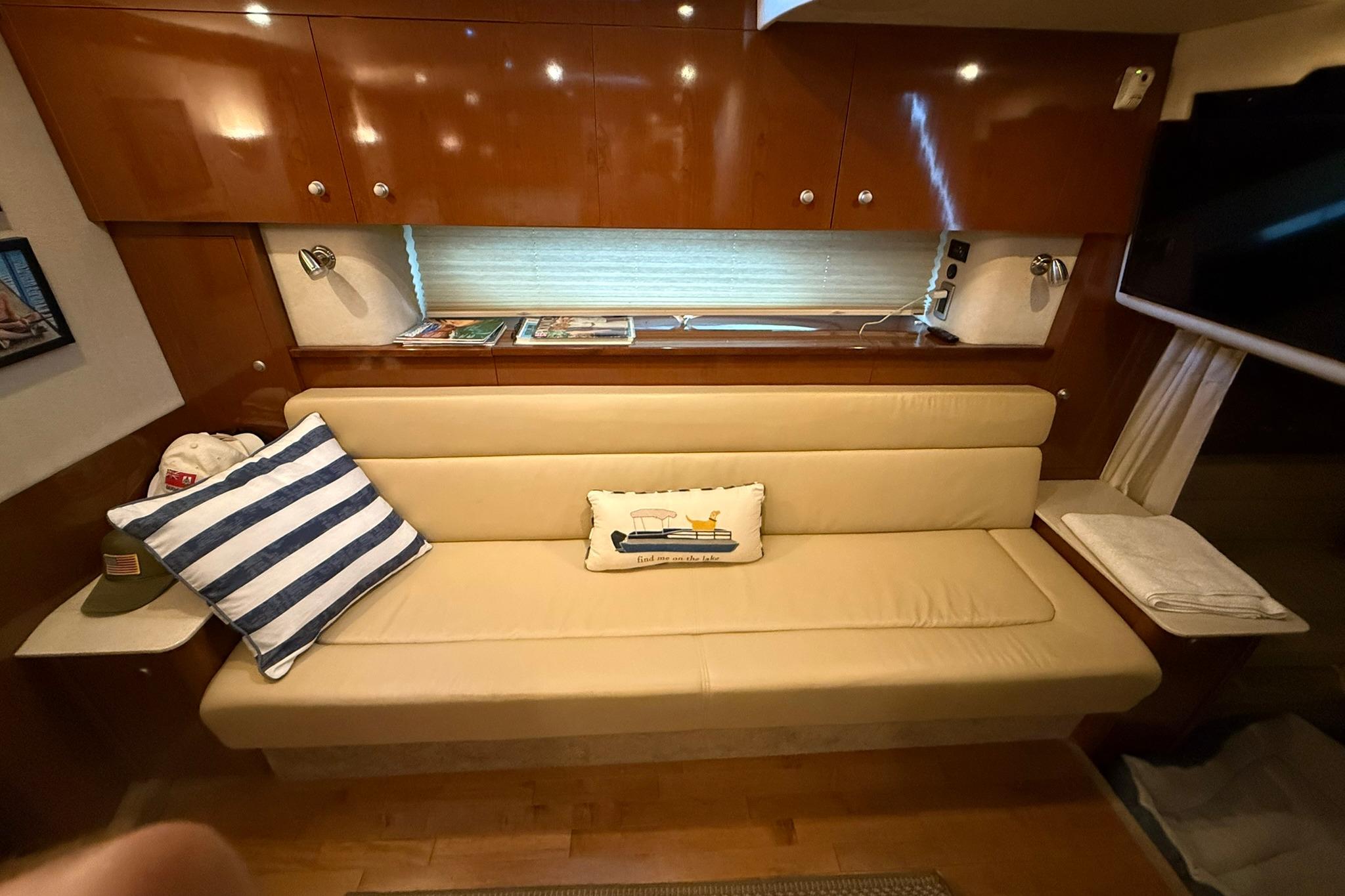 Interior of 2009 Sea Ray 350 Sundancer with beige seating and nautical decor.