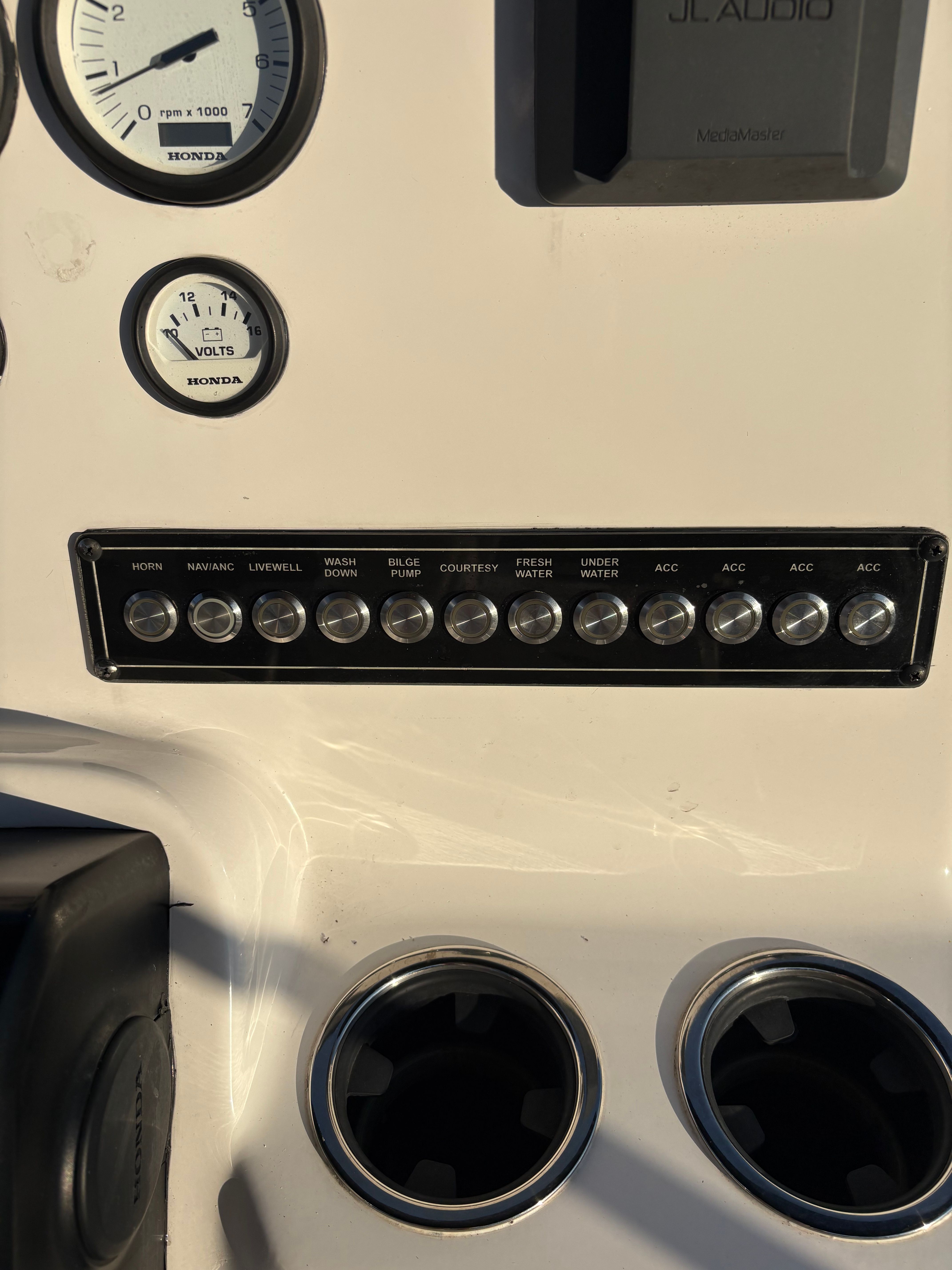 Dashboard with switches and gauges on a boat.