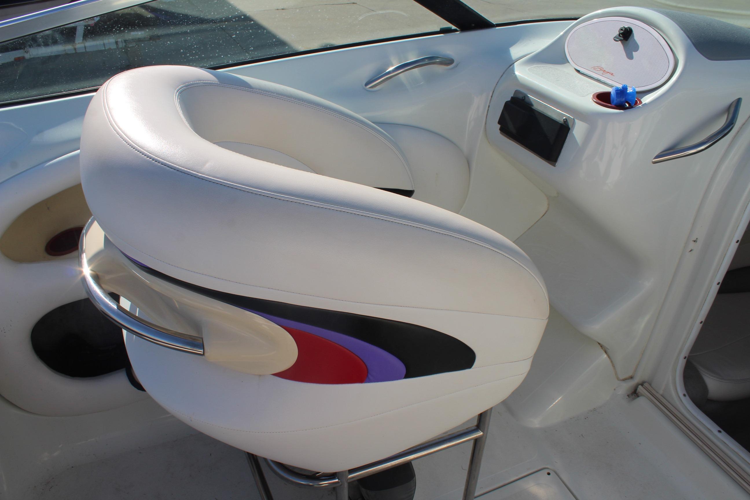 White leather seat in 1996 Baja 232 boat interior, featuring colorful accents and sleek design.