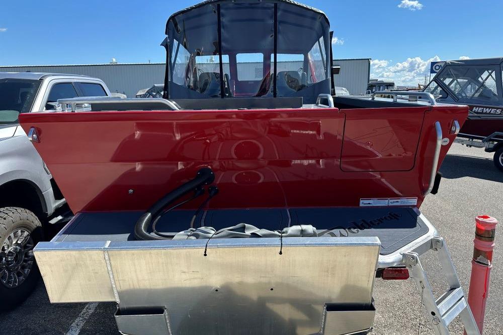 2026 Weldcraft 240 Maverick DV boat, red exterior, parked outdoors under clear sky.