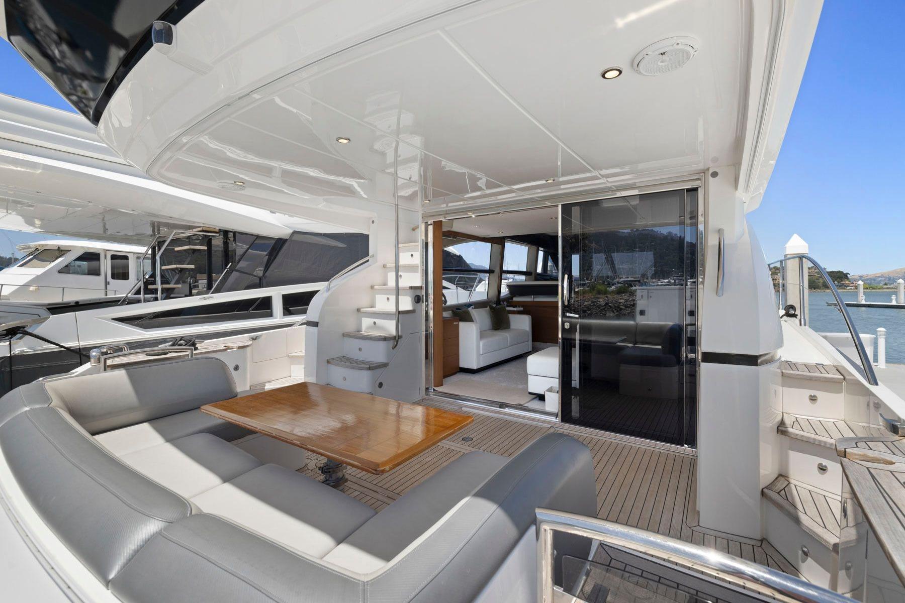 Luxurious 2015 Princess 60 Flybridge Motor Yacht with spacious seating and elegant interior.