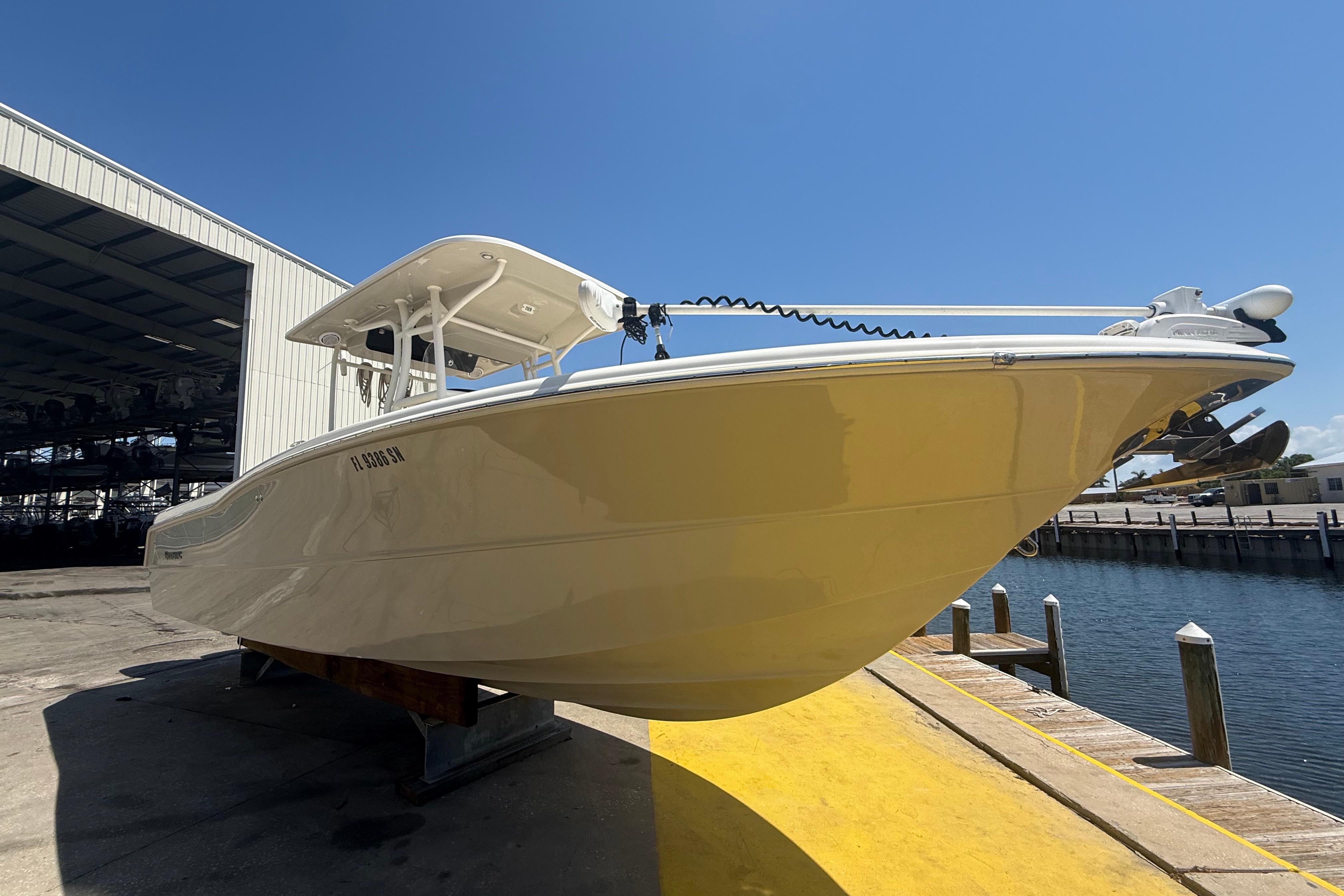 2019 Key West Billistic 281 Center Console boat docked near a marina.