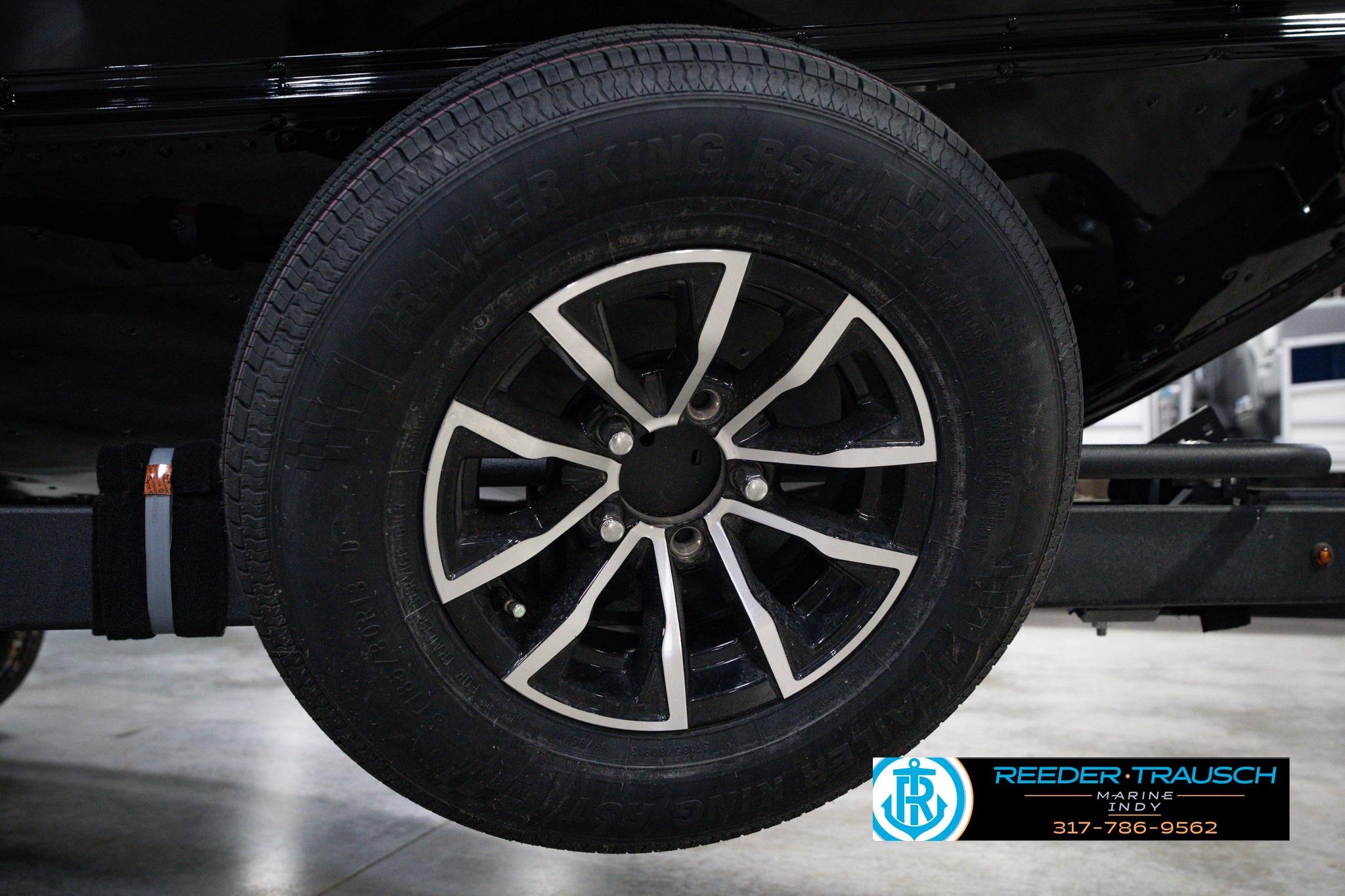 2026 Lund 1875 Impact XS SS trailer wheel, black alloy rim, close-up view.