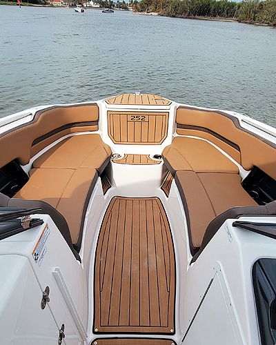 Luxurious interior of 2024 Yamaha Boats 252SE on calm waters.