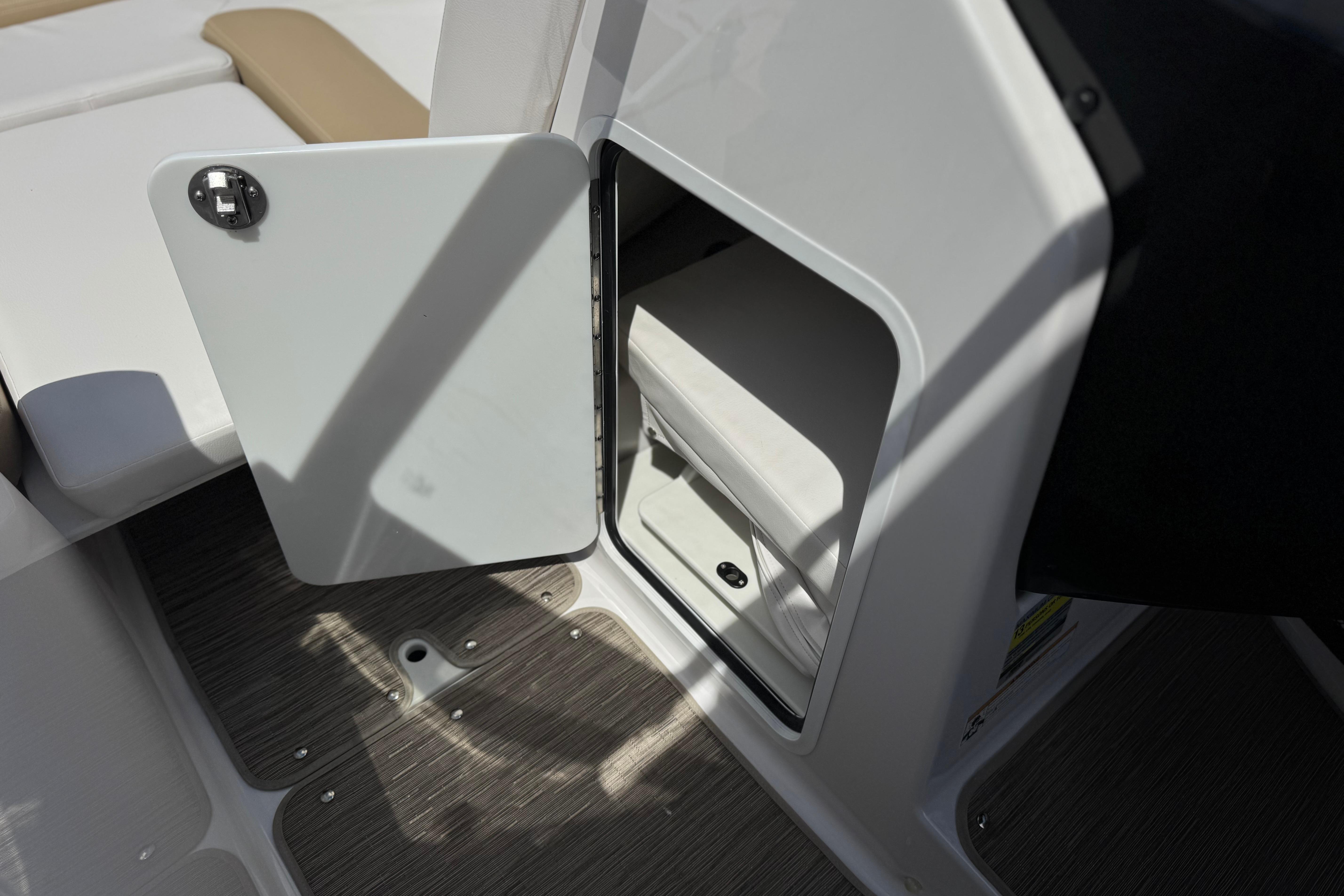 Open storage compartment on 2017 Scarab 255 H.O. Platinum boat, featuring sleek interior design.