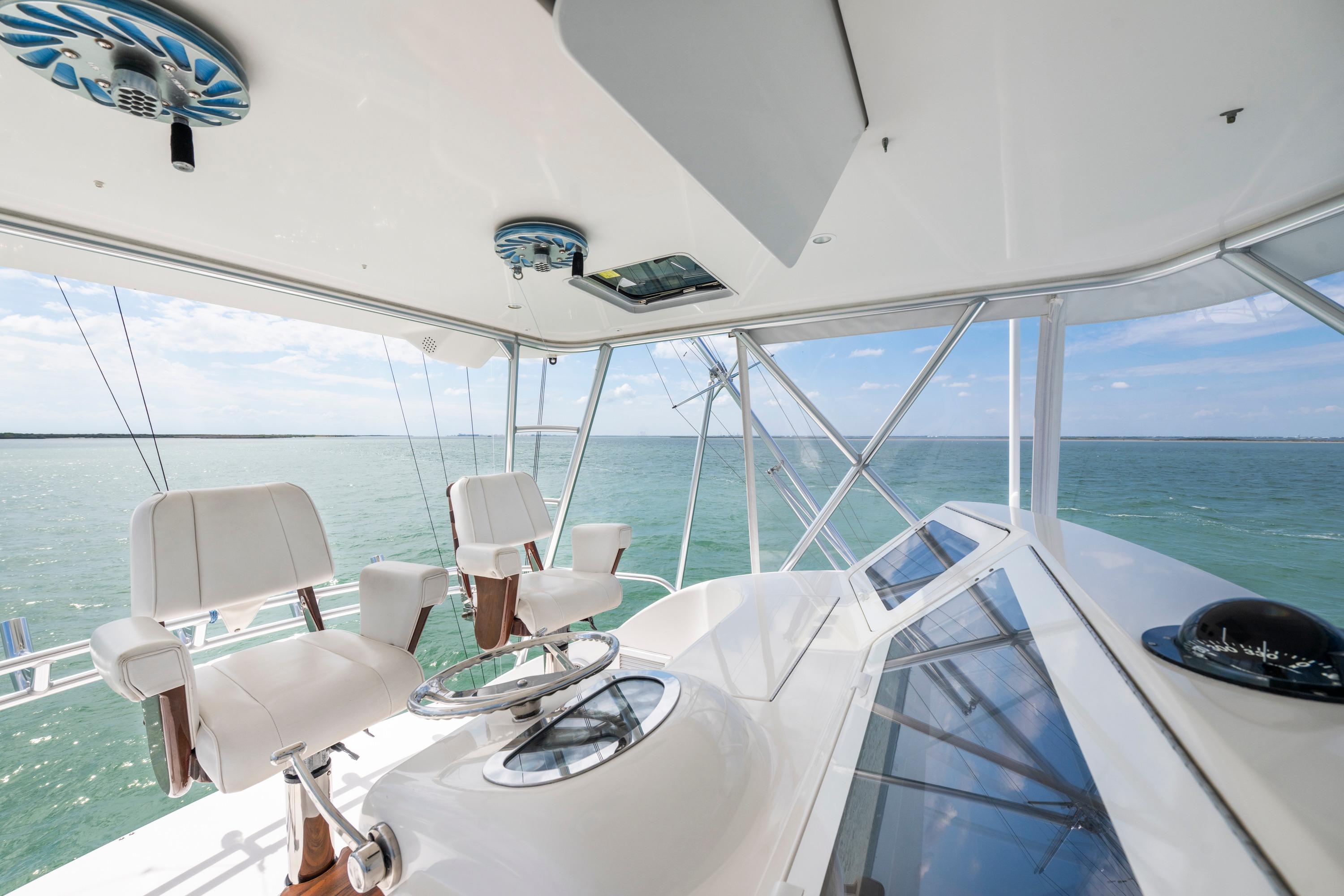Interior view of 2009 Viking 50 Convertible yacht helm with ocean backdrop.
