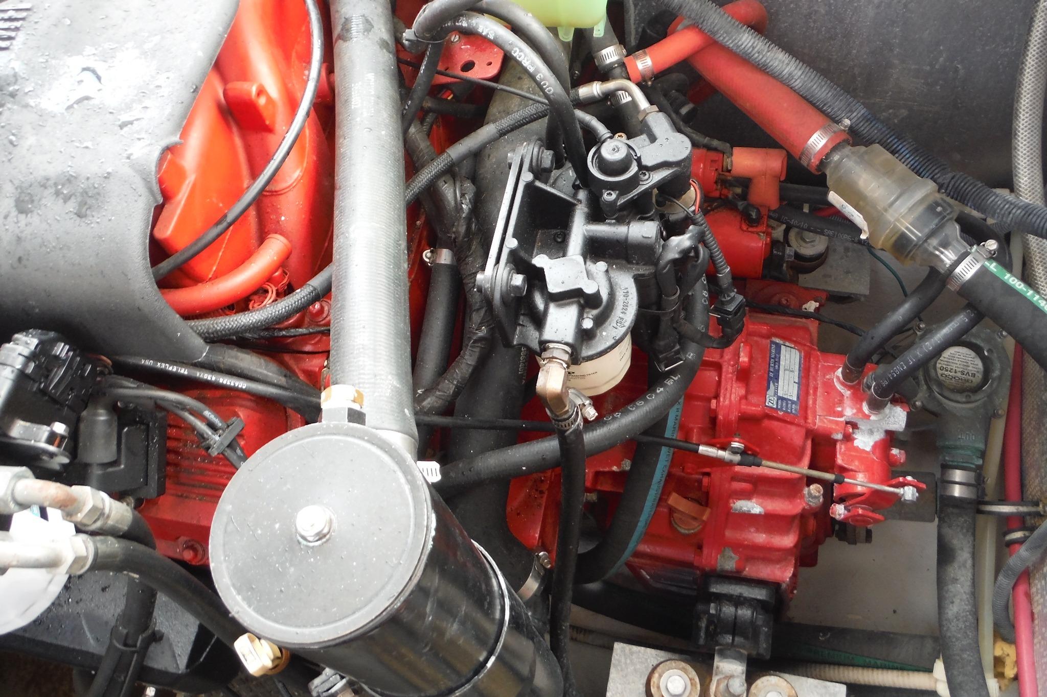 Engine compartment of a 2005 Chaparral Signature 350 boat, showcasing intricate mechanical components.
