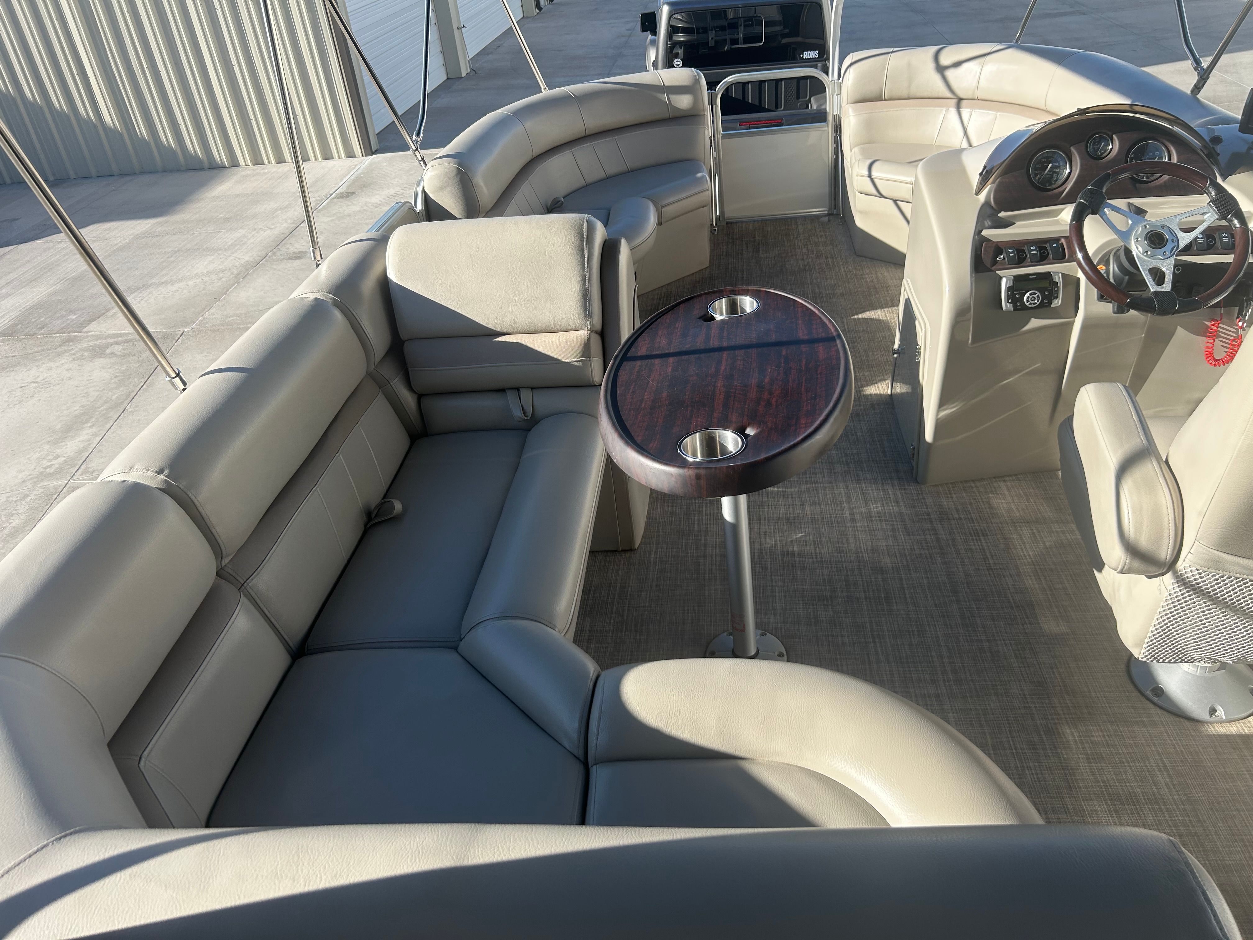 The image shows the interior of a 2018 Berkshire 24RFX CTS pontoon boat with beige leather seating.
