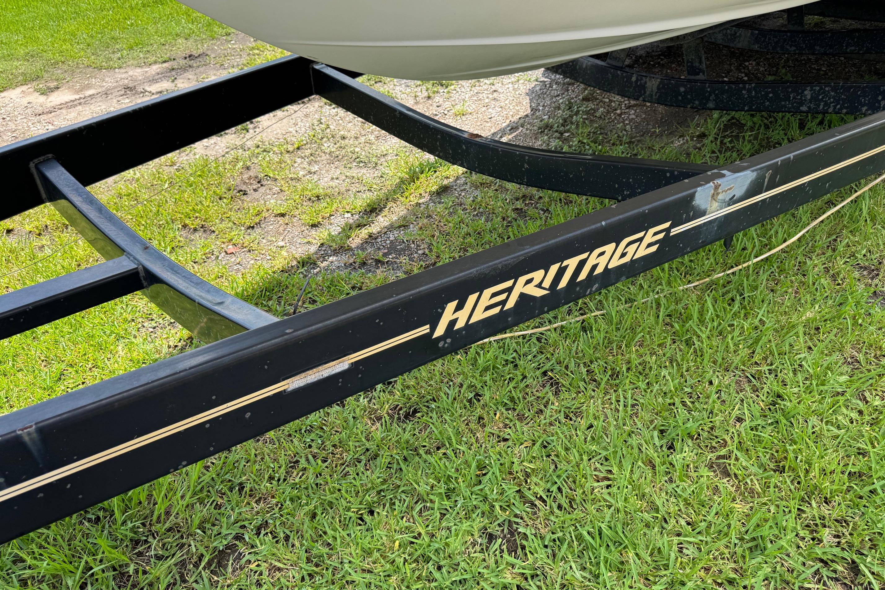 Boat trailer labeled "Heritage" on grass, for 2000 Maxum 2400 SCR.