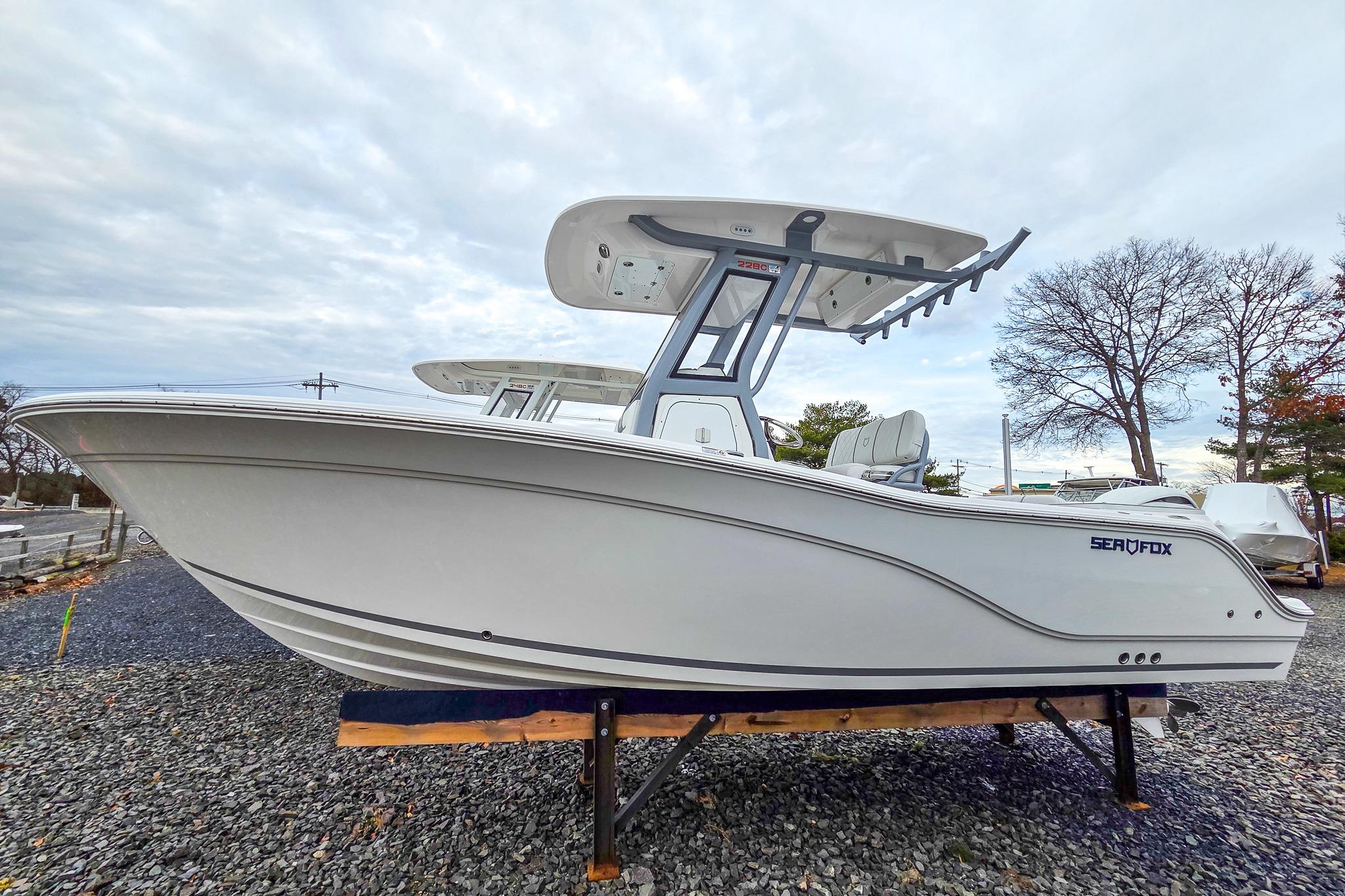 2026 Sea Fox 228 Commander boat on display, side view with overcast sky.