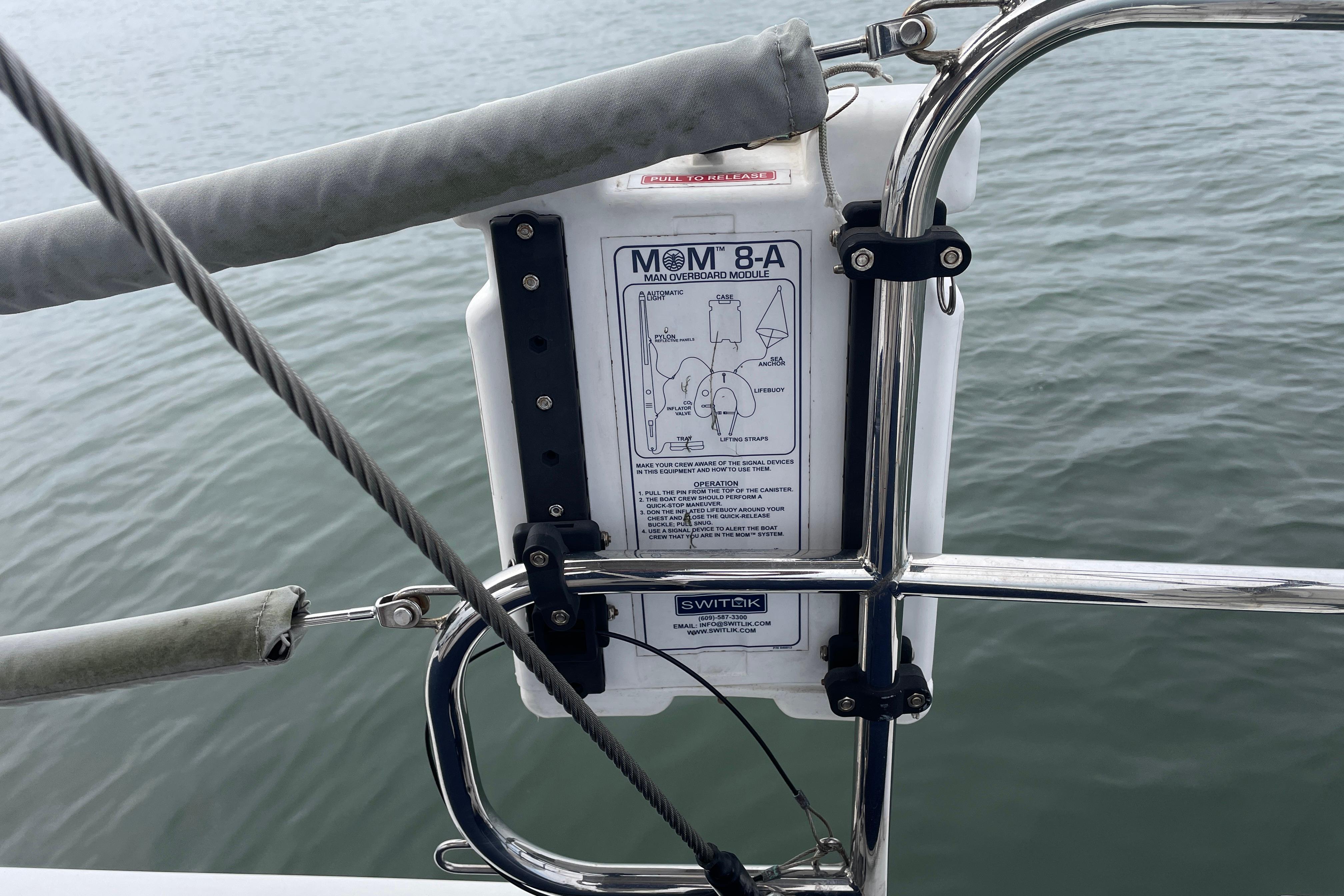 Man overboard module on 2014 Hanse 415 yacht, secured to railing above water.
