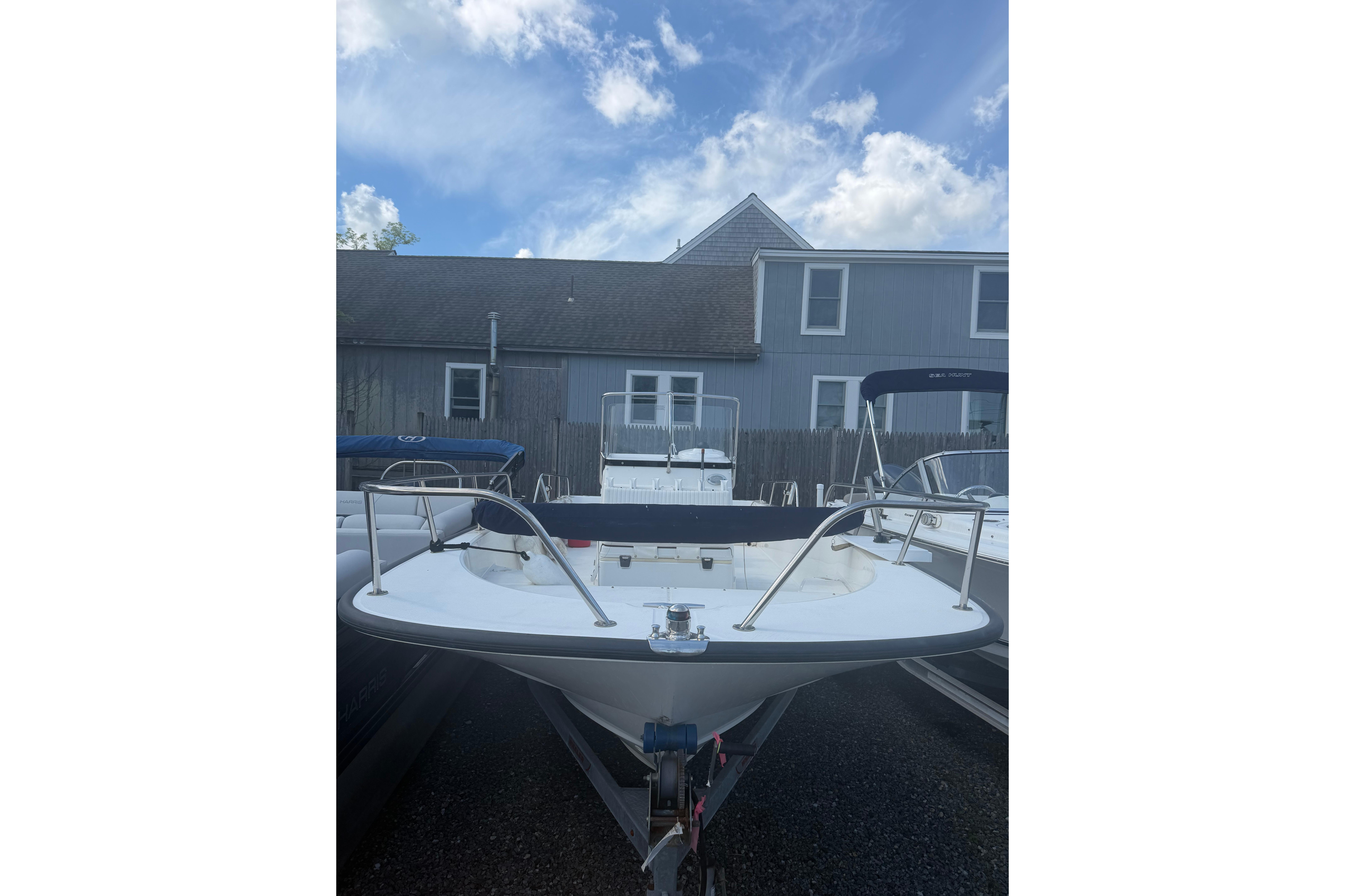 2015 Boston Whaler 210 Montauk boat parked outdoors under a blue sky.