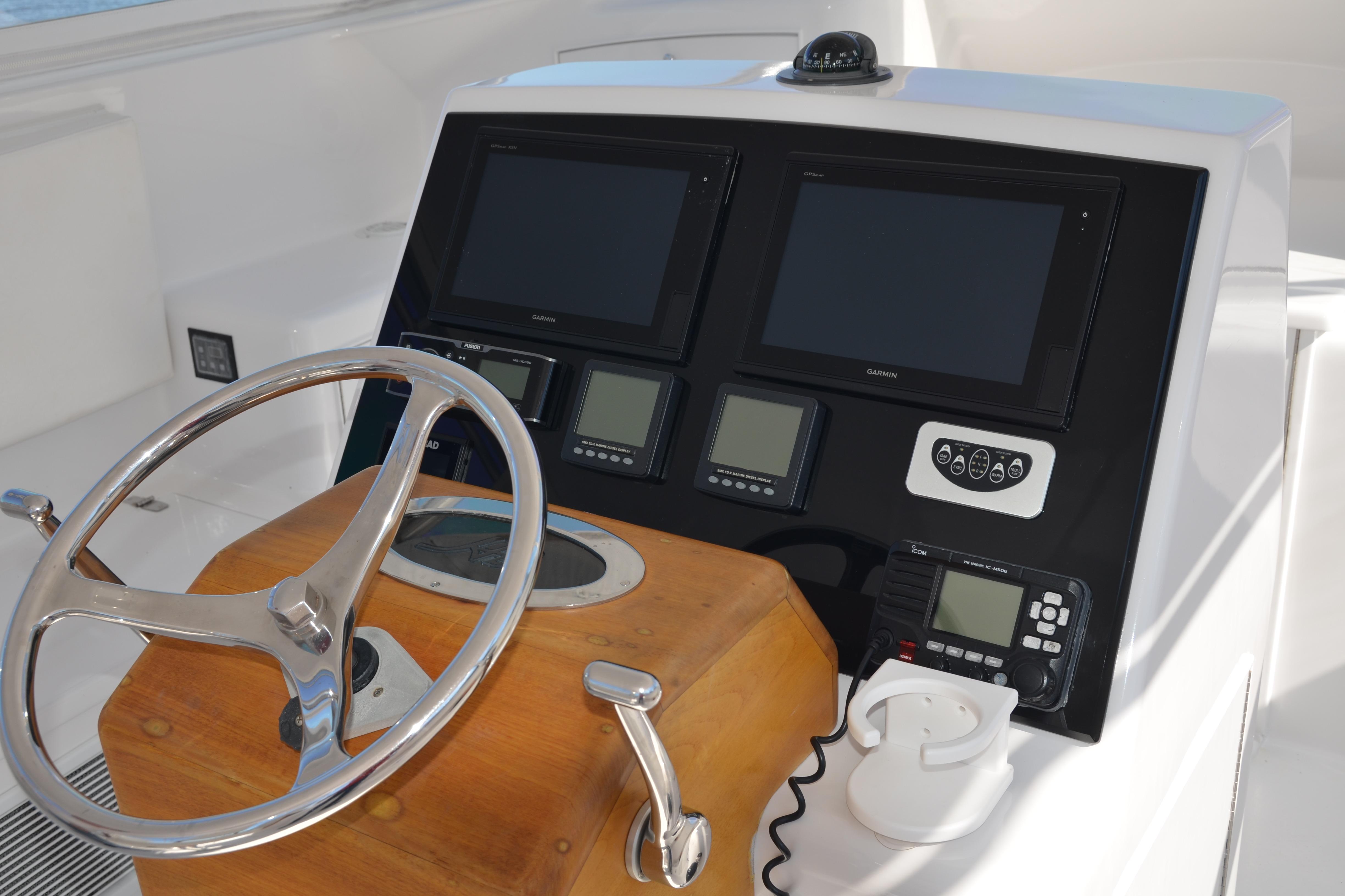 Helm of 2006 Custom Carolina Heritage Express boat with navigation screens and controls.