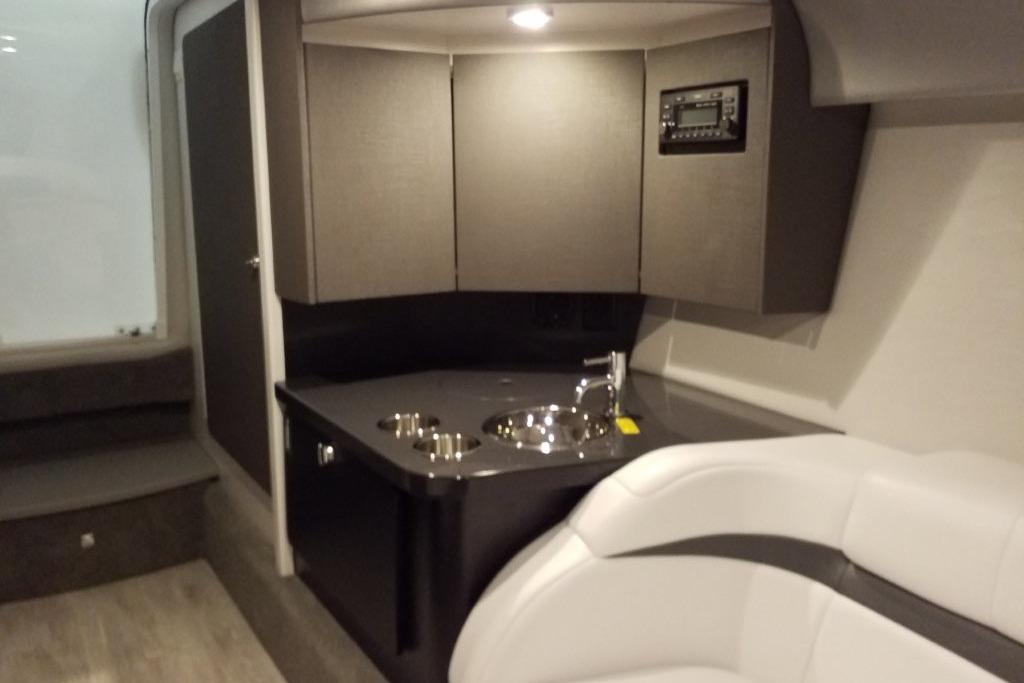 2019 Formula 382 FASTech cabin interior with modern kitchenette and seating area.