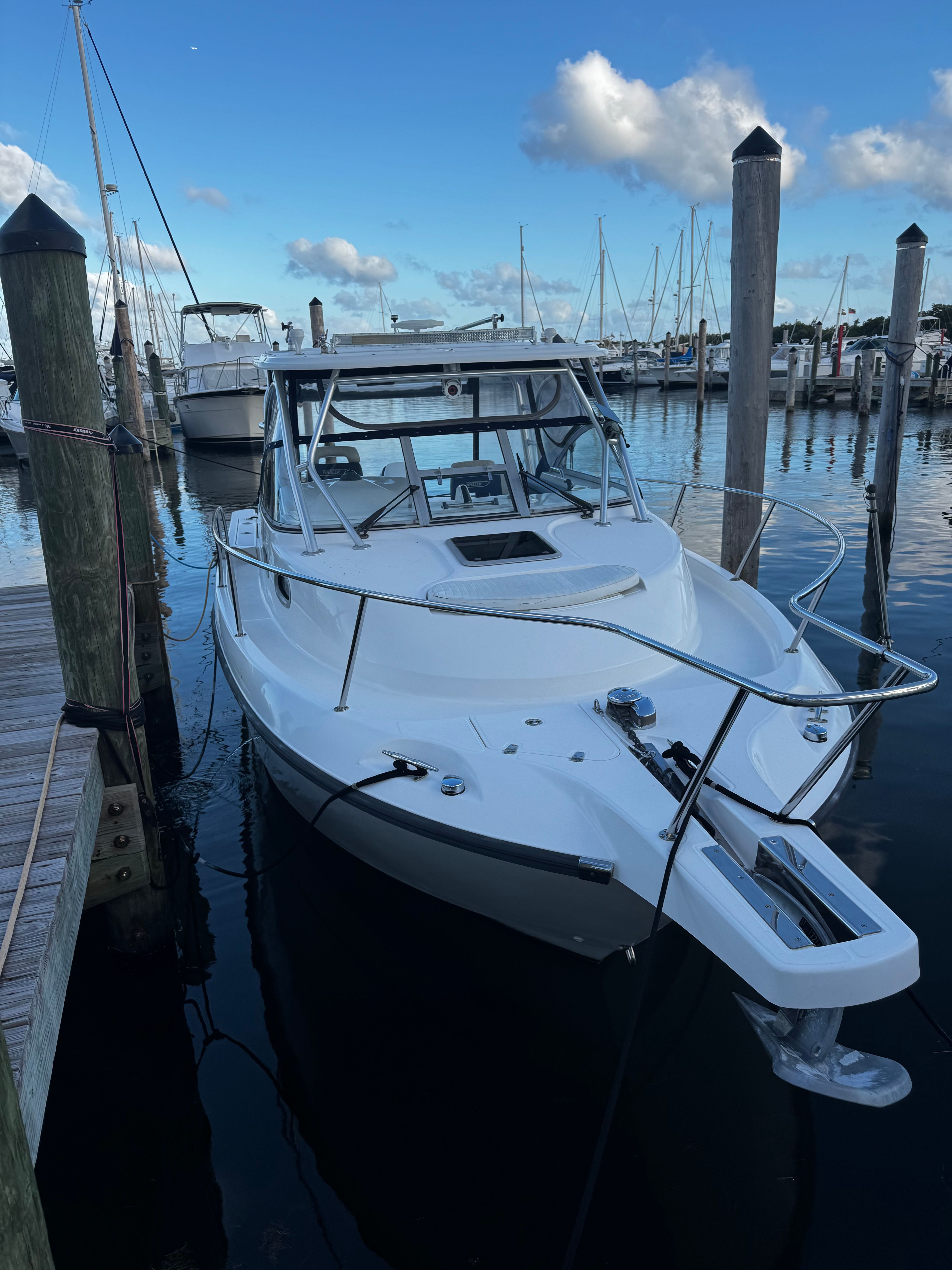 2005 Boston Whaler 305 Conquest docked at marina.