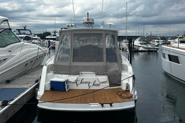 2013 Beneteau Gran Turismo 38 yacht docked at marina under cloudy skies.