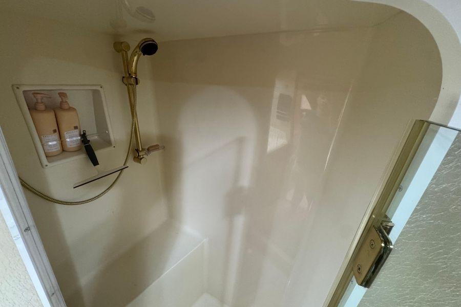 Shower area in 2002 Viking 61 Enclosed Bridge yacht with built-in toiletries.