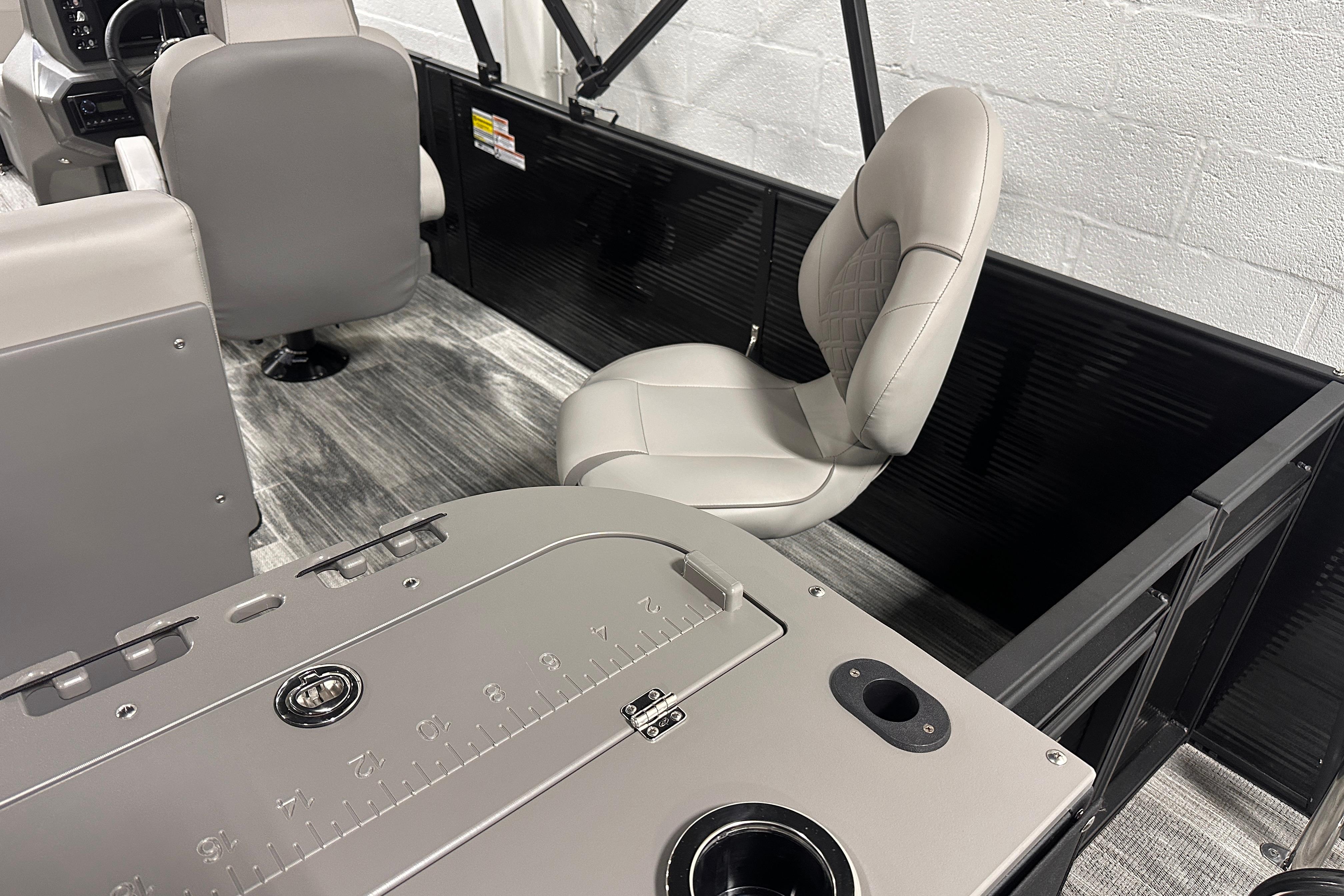Interior of 2025 Qwest 18 XRE Cruise boat with modern seating and dashboard.
