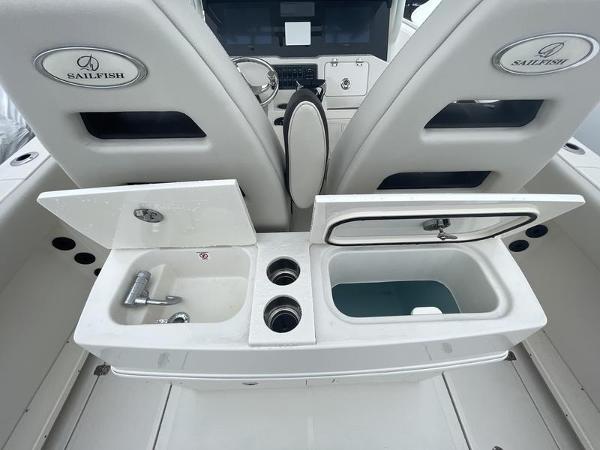 2023 Sailfish 290 CC boat interior with sink and storage compartments.