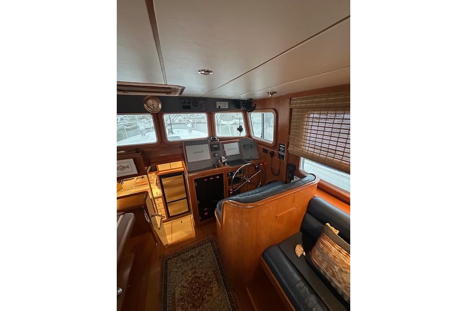 2001 Nordhavn 35 Coastal Pilot interior with helm, seating, and navigation equipment.