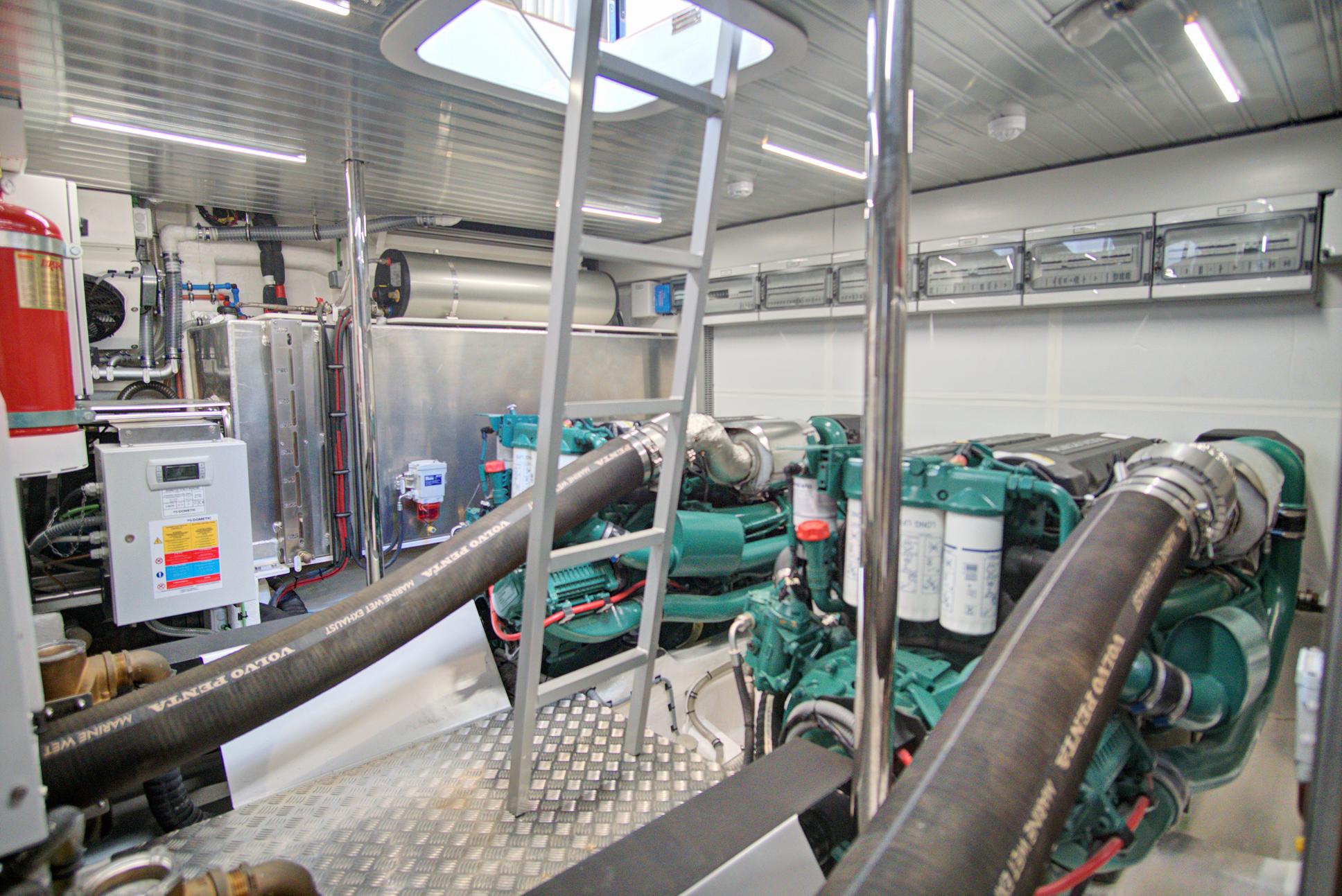 Engine room of 2023 Astondoa AS5 yacht with modern equipment and ladder.
