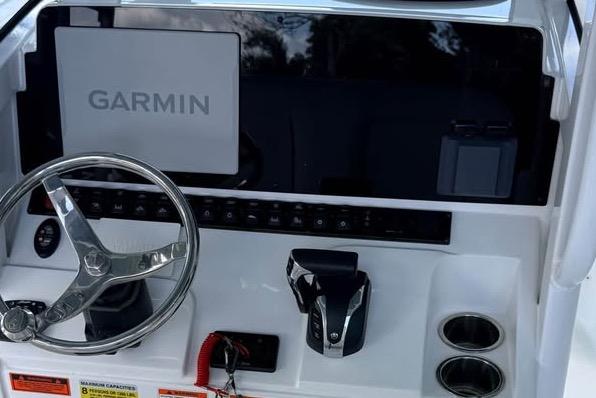 2023 Sea Hunt Ultra 239 SE boat dashboard with Garmin navigation system and steering wheel.