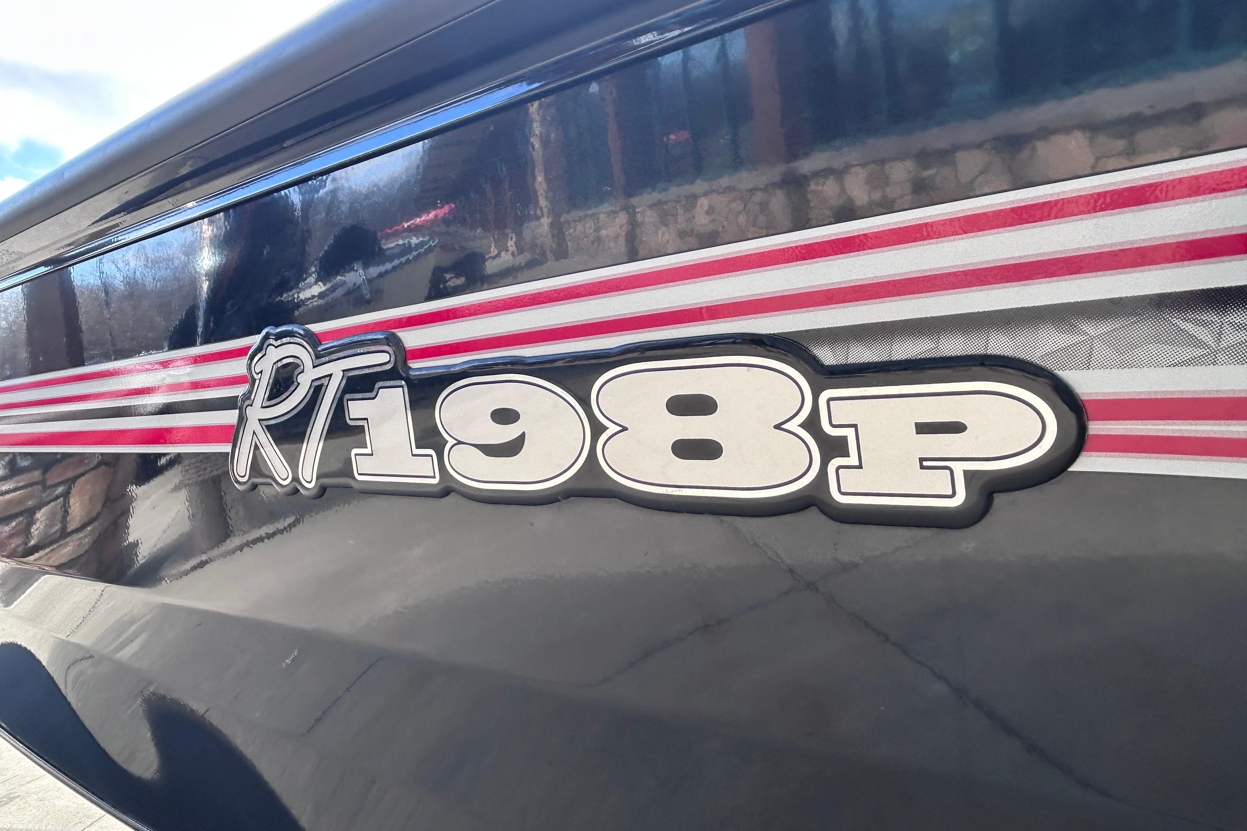 2025 Ranger RT198P boat logo with red and white stripes on a sleek black surface.