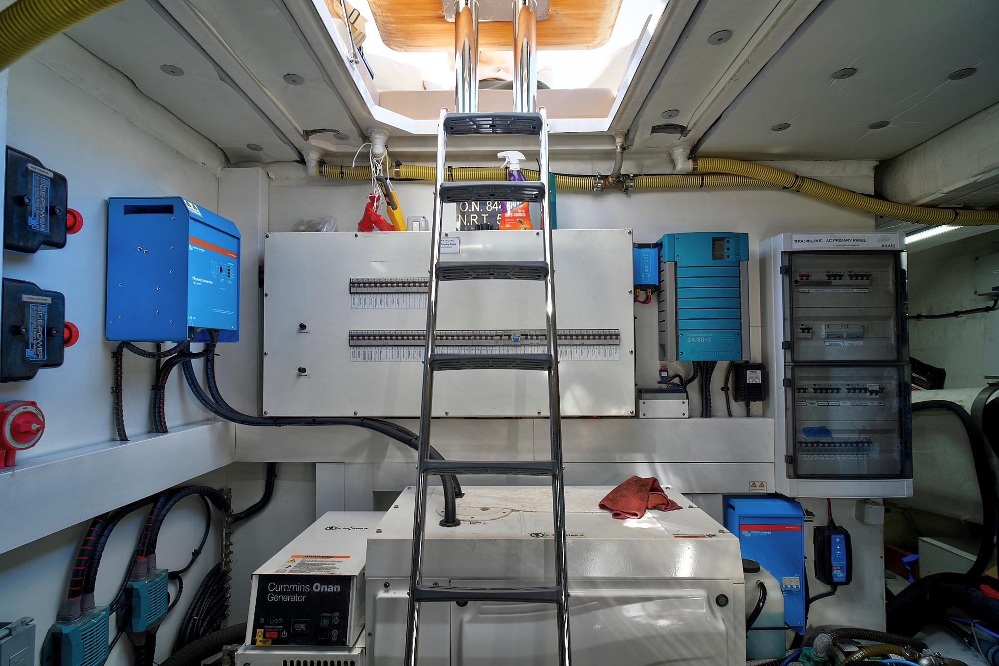 Engine room of 2021 Fairline Squadron 68 yacht with electrical panels and generator.